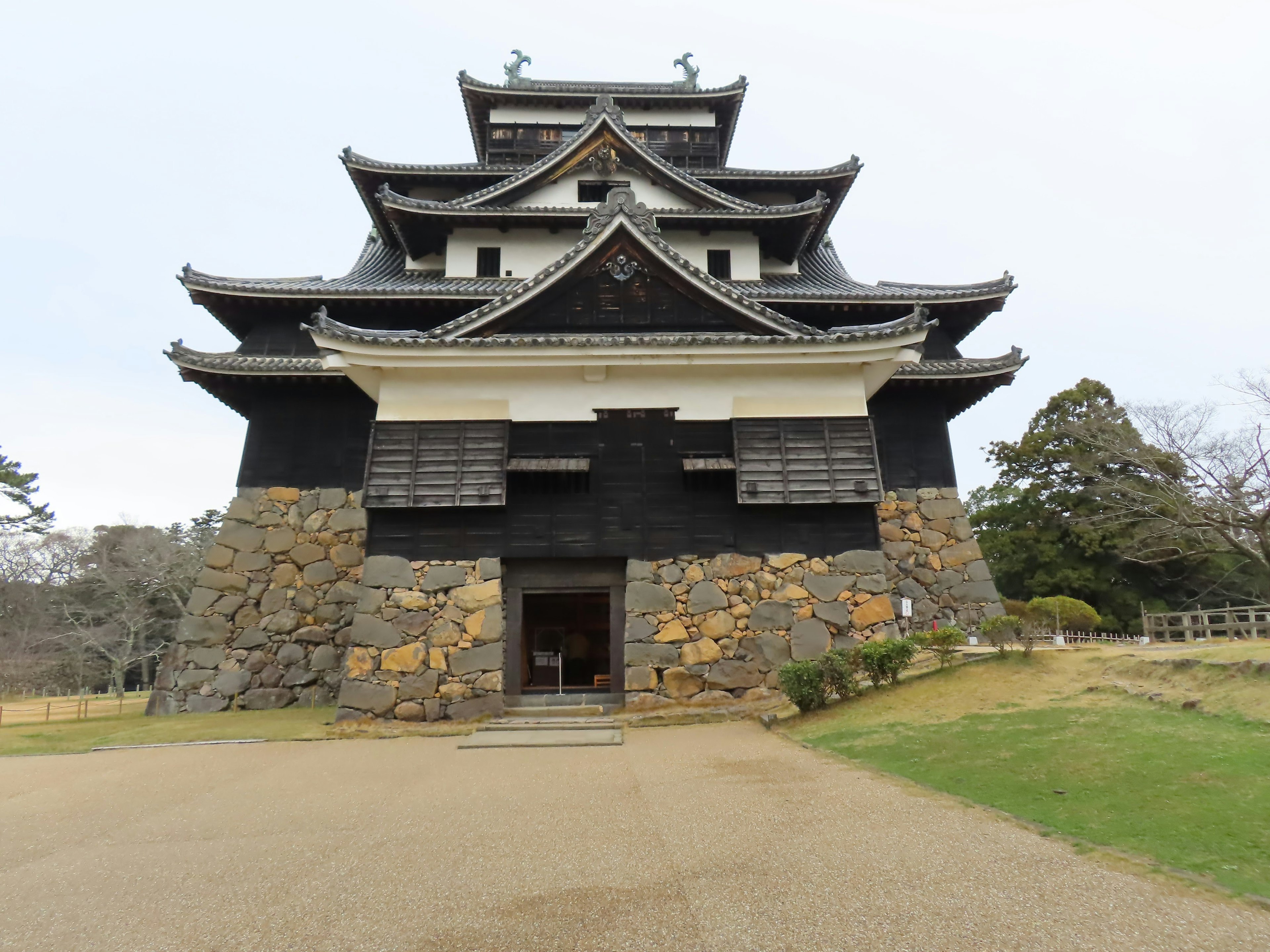 Historic castle exterior featuring black stone walls and white wooden accents