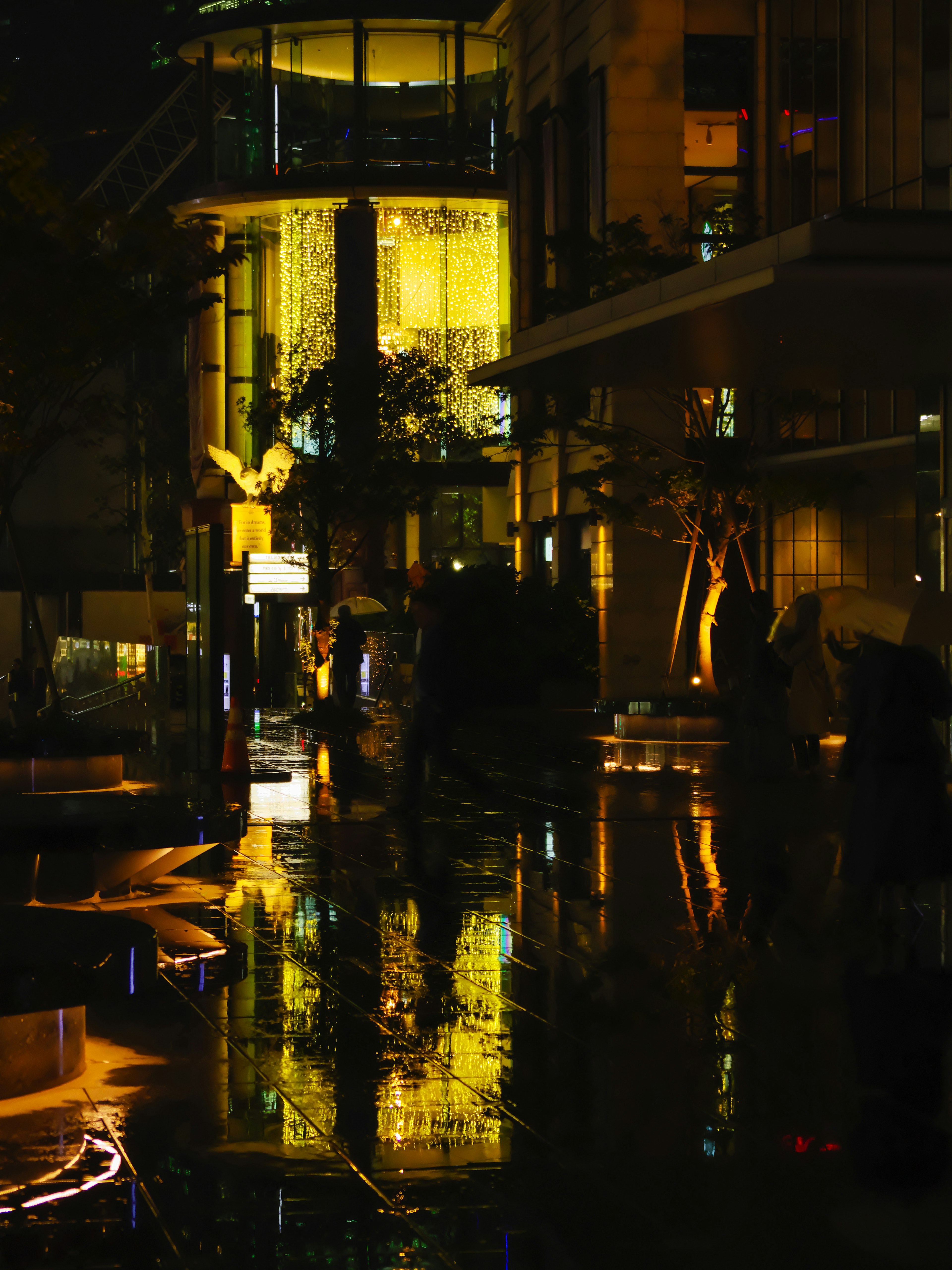 Nighttime urban scene with reflections of neon lights and warm illumination