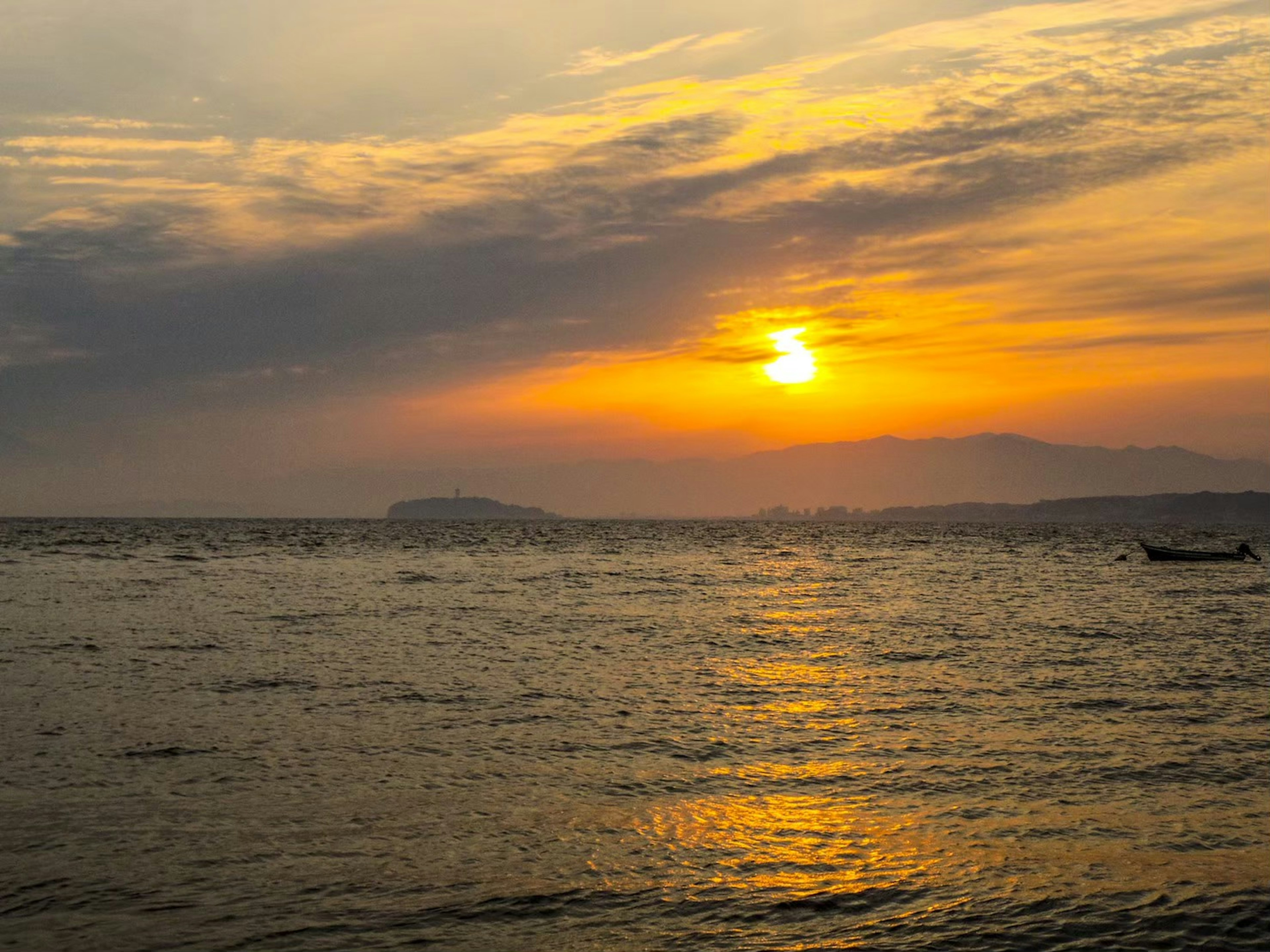 Beautiful sunset over the ocean with orange reflections on the water