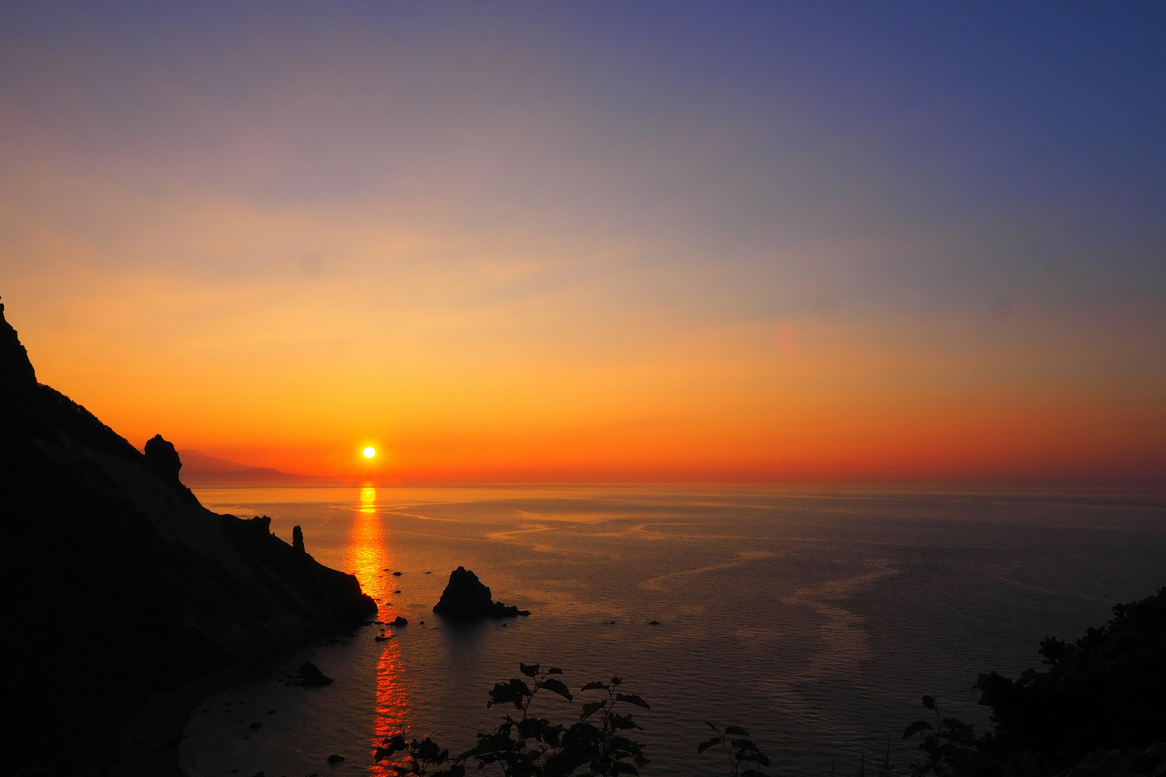 海面上的美丽日落，橙色和蓝色渐变的颜色