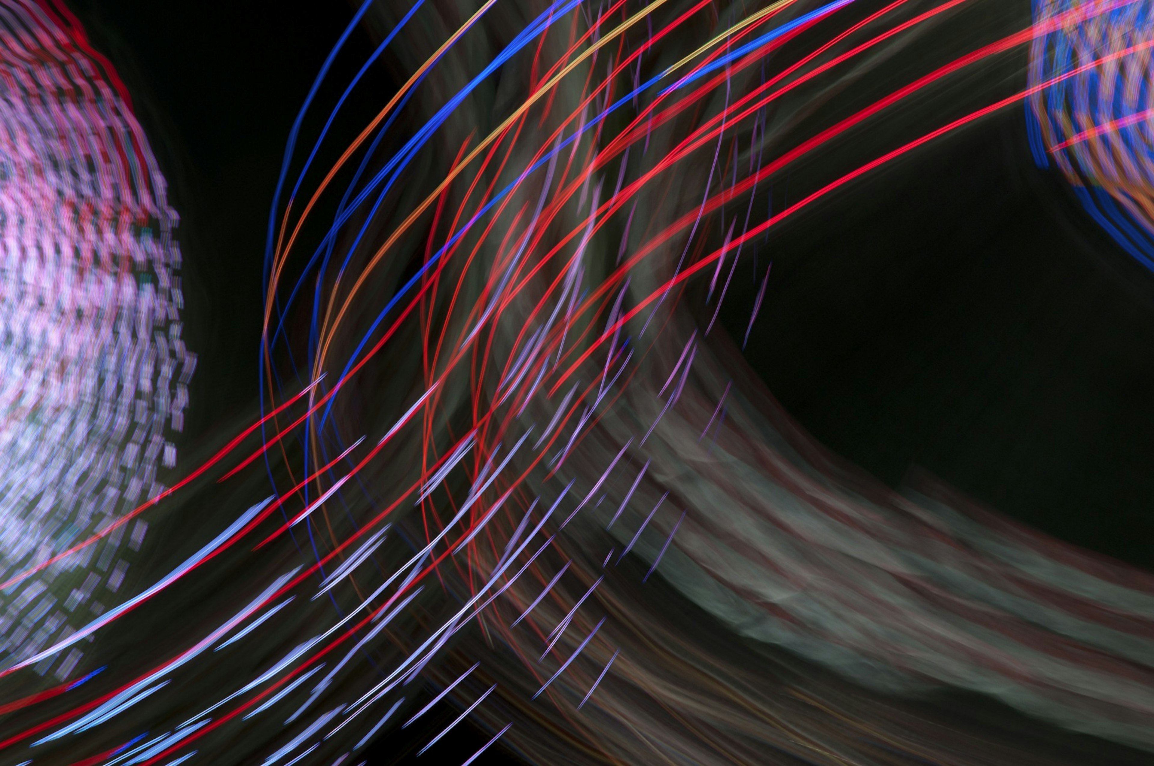 Abstract image featuring colorful light trails intersecting