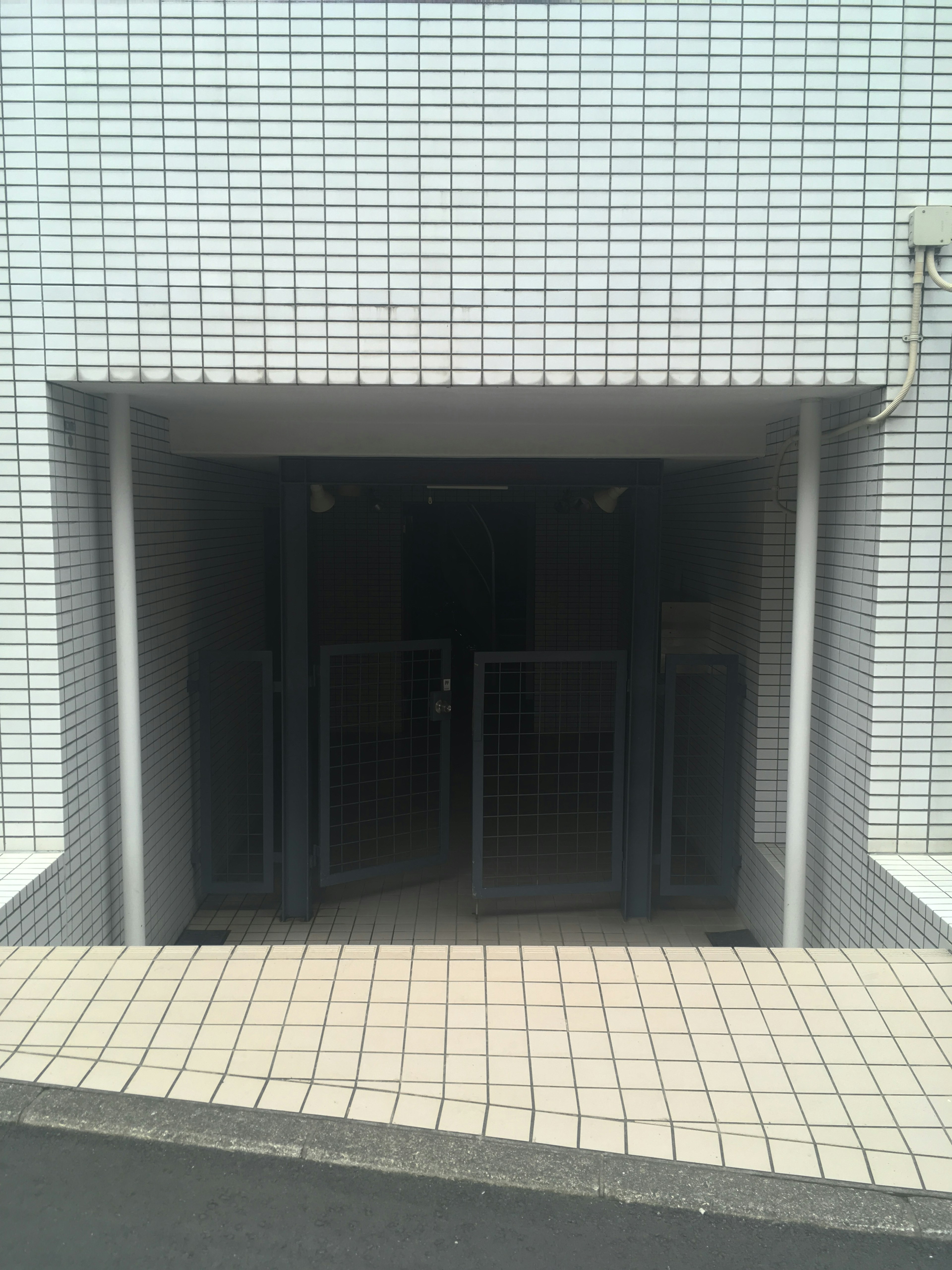 Underground entrance with gates in a tiled building