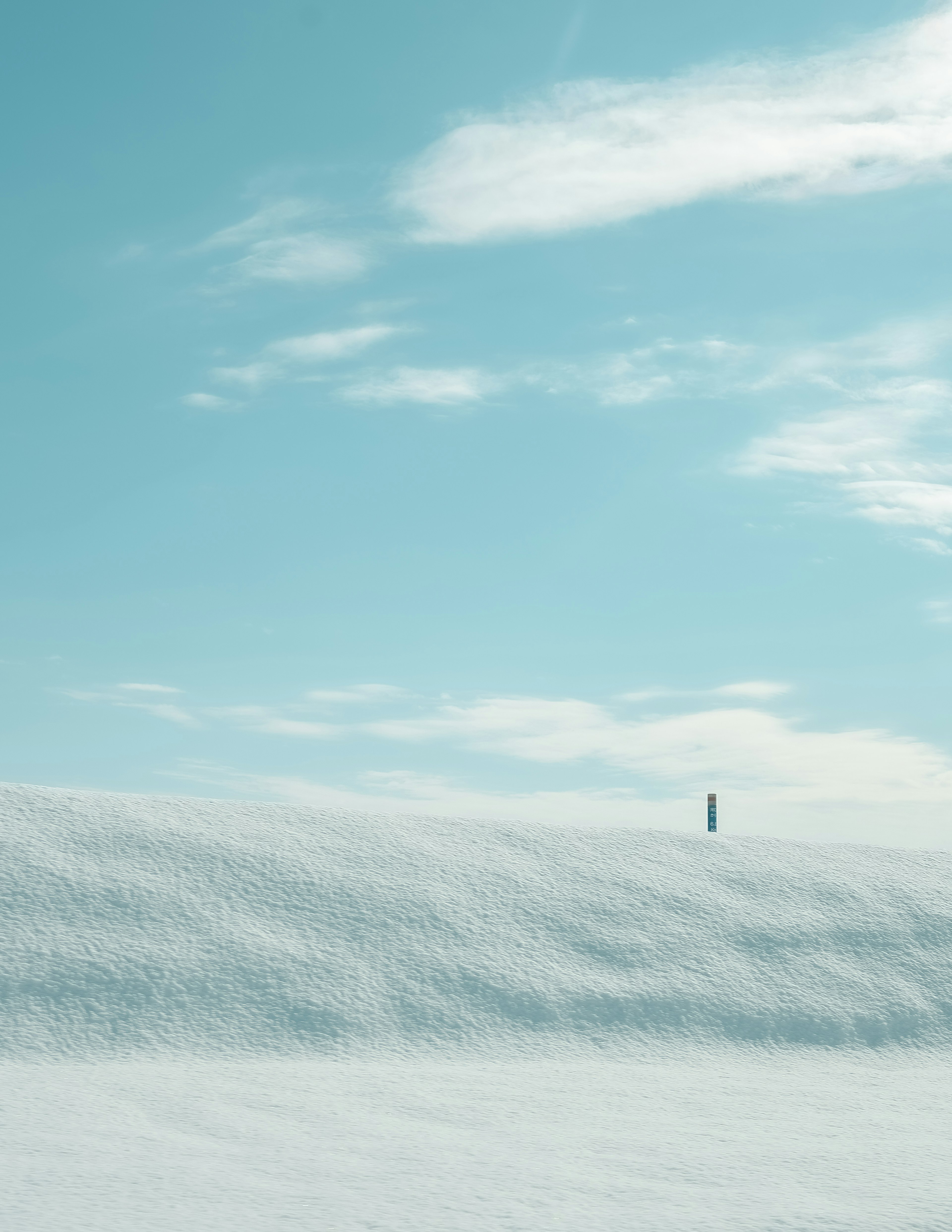 Snow-covered landscape with a bright blue sky