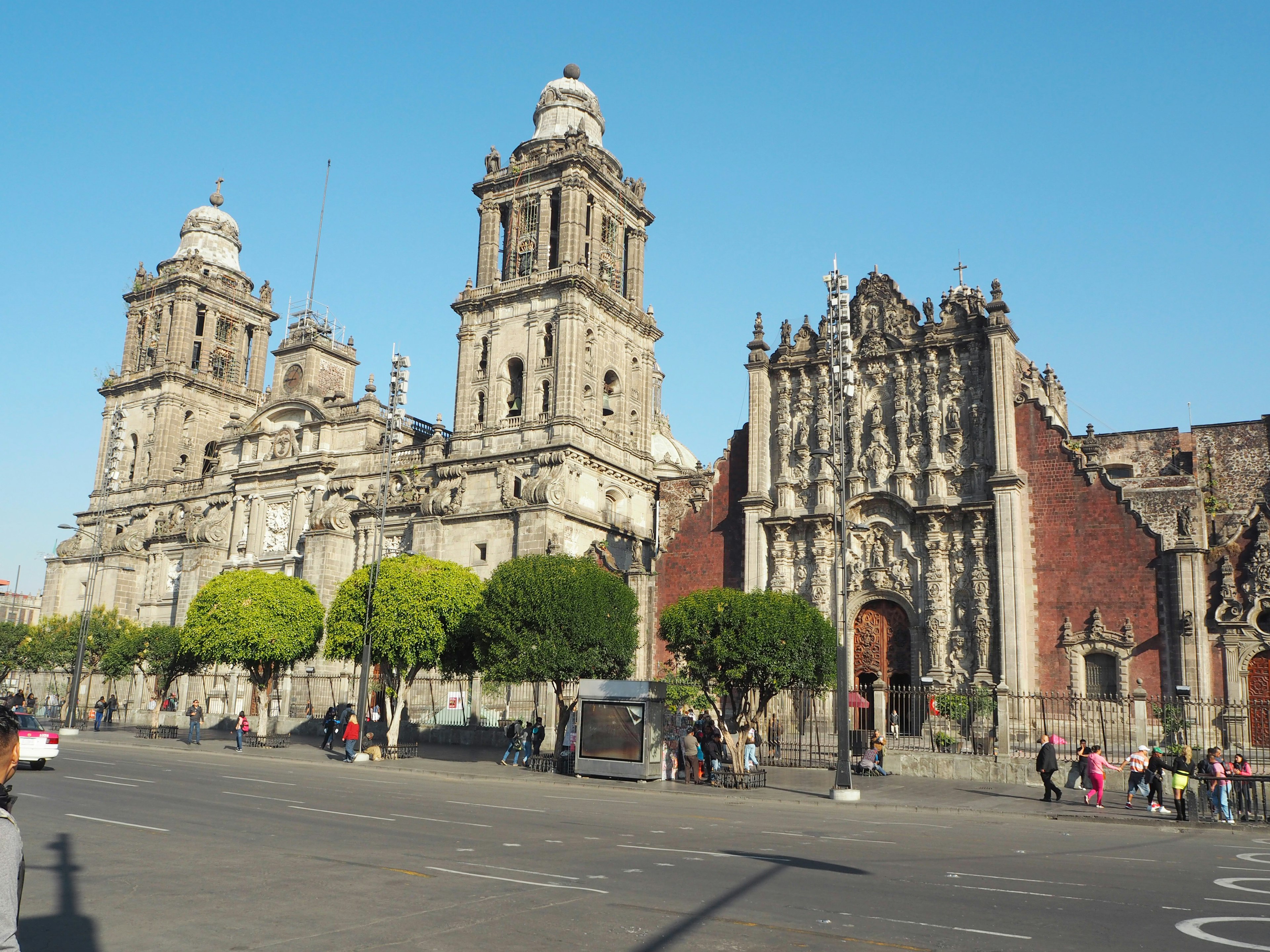 Historic buildings in Mexico City featuring grand churches and towers under a clear blue sky