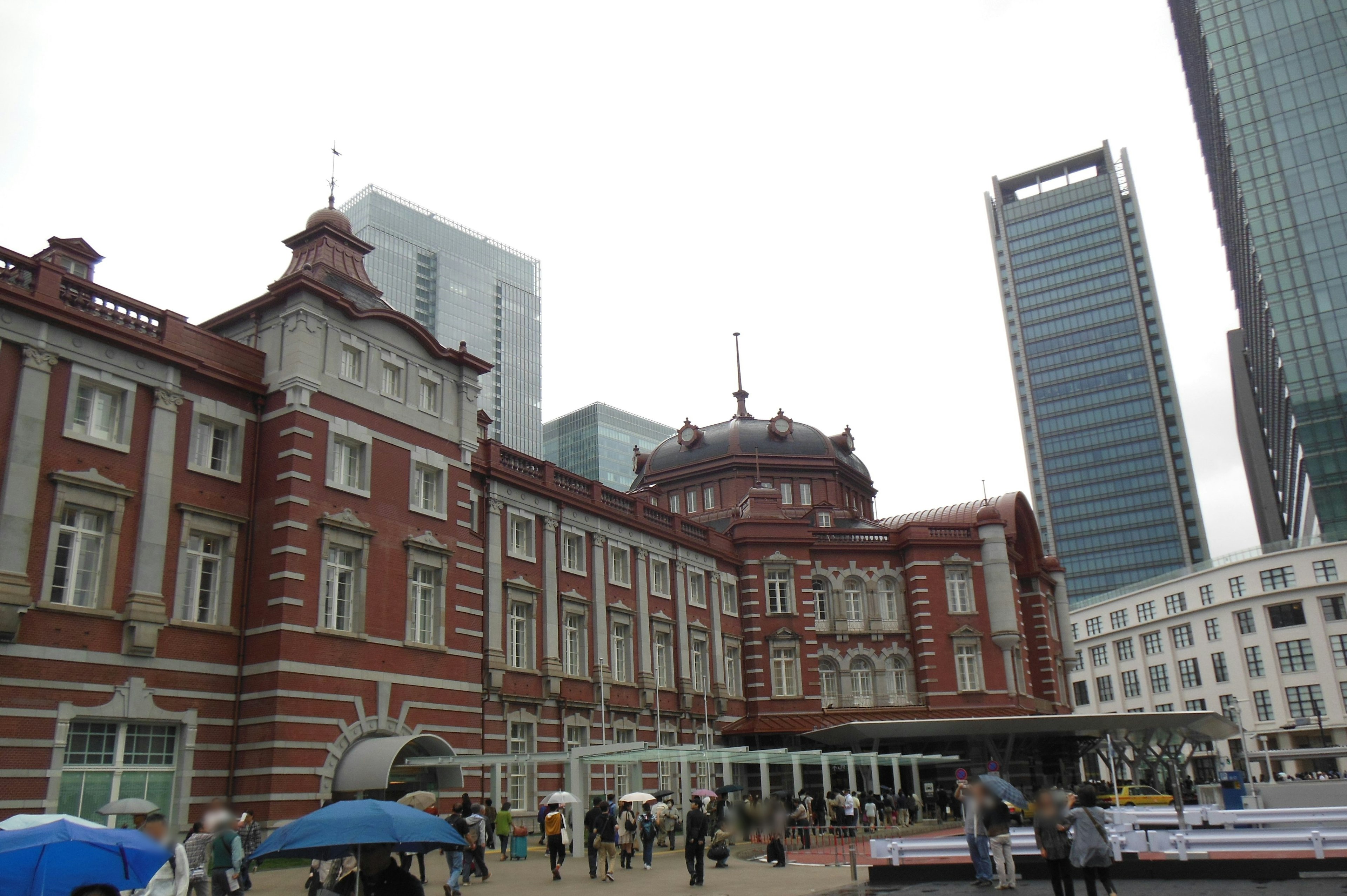 Tokyo Station's red brick architecture alongside modern skyscrapers