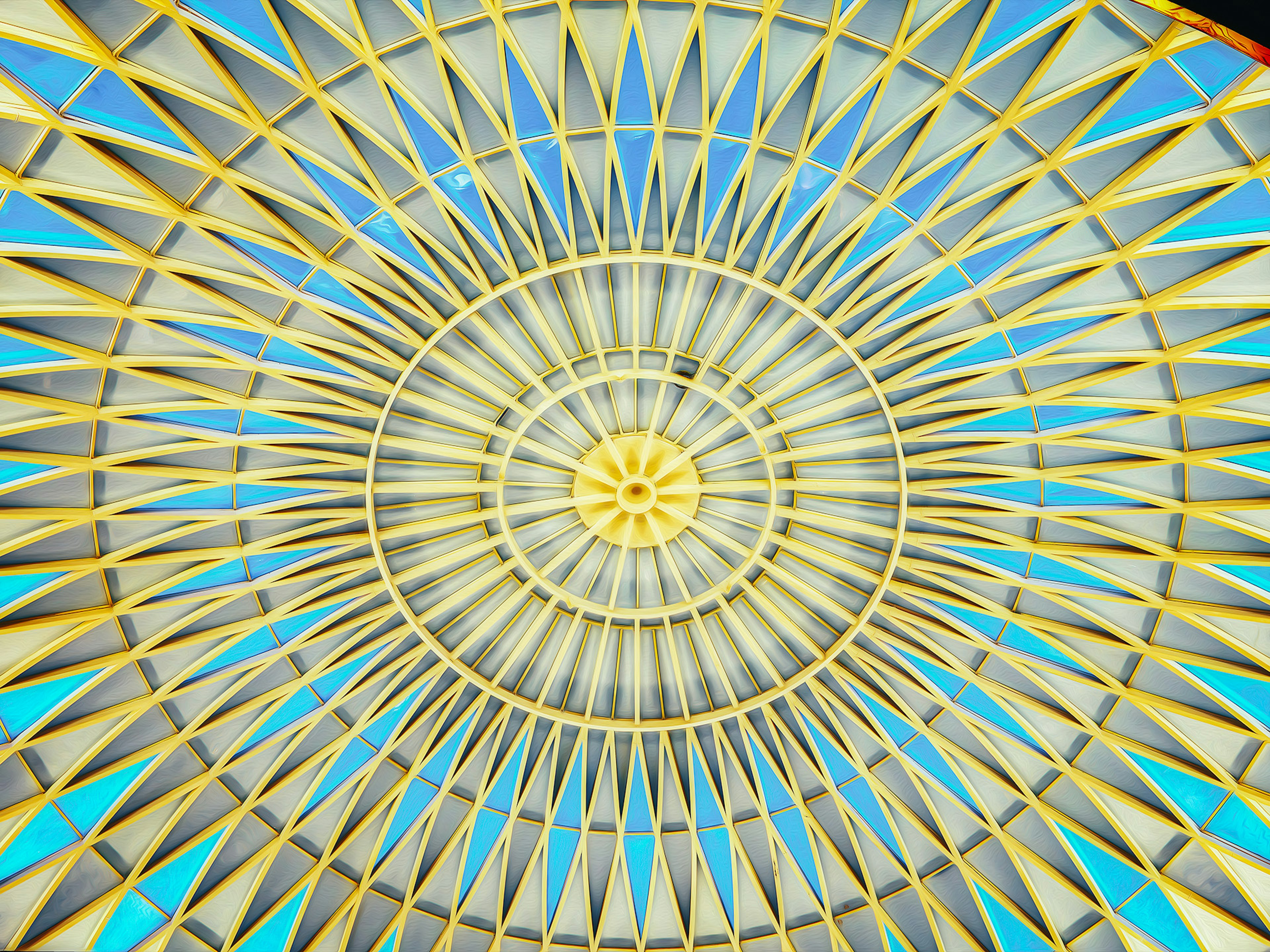 Radiating yellow ceiling design against a blue sky background