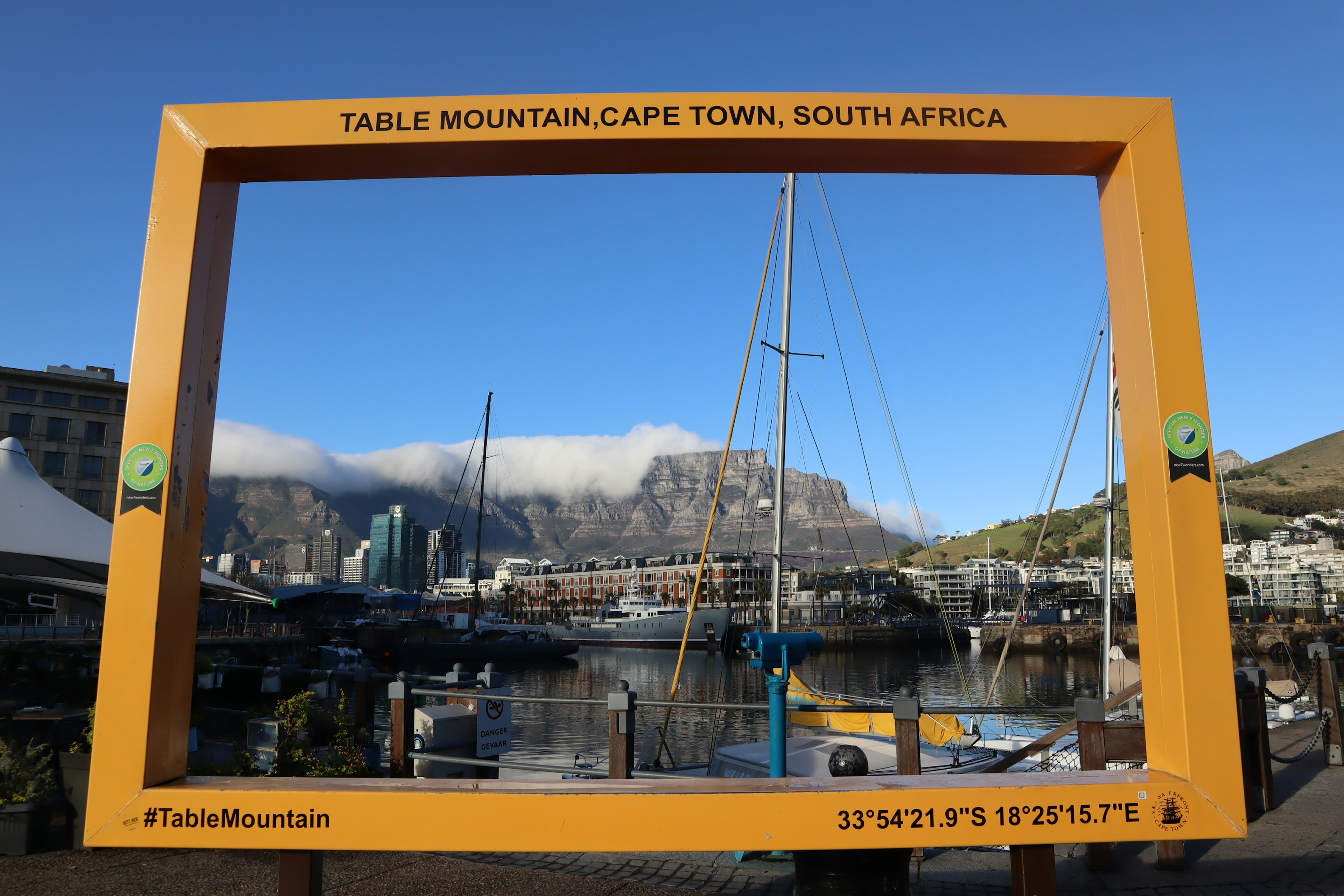 Image of Table Mountain framed with boats in the harbor