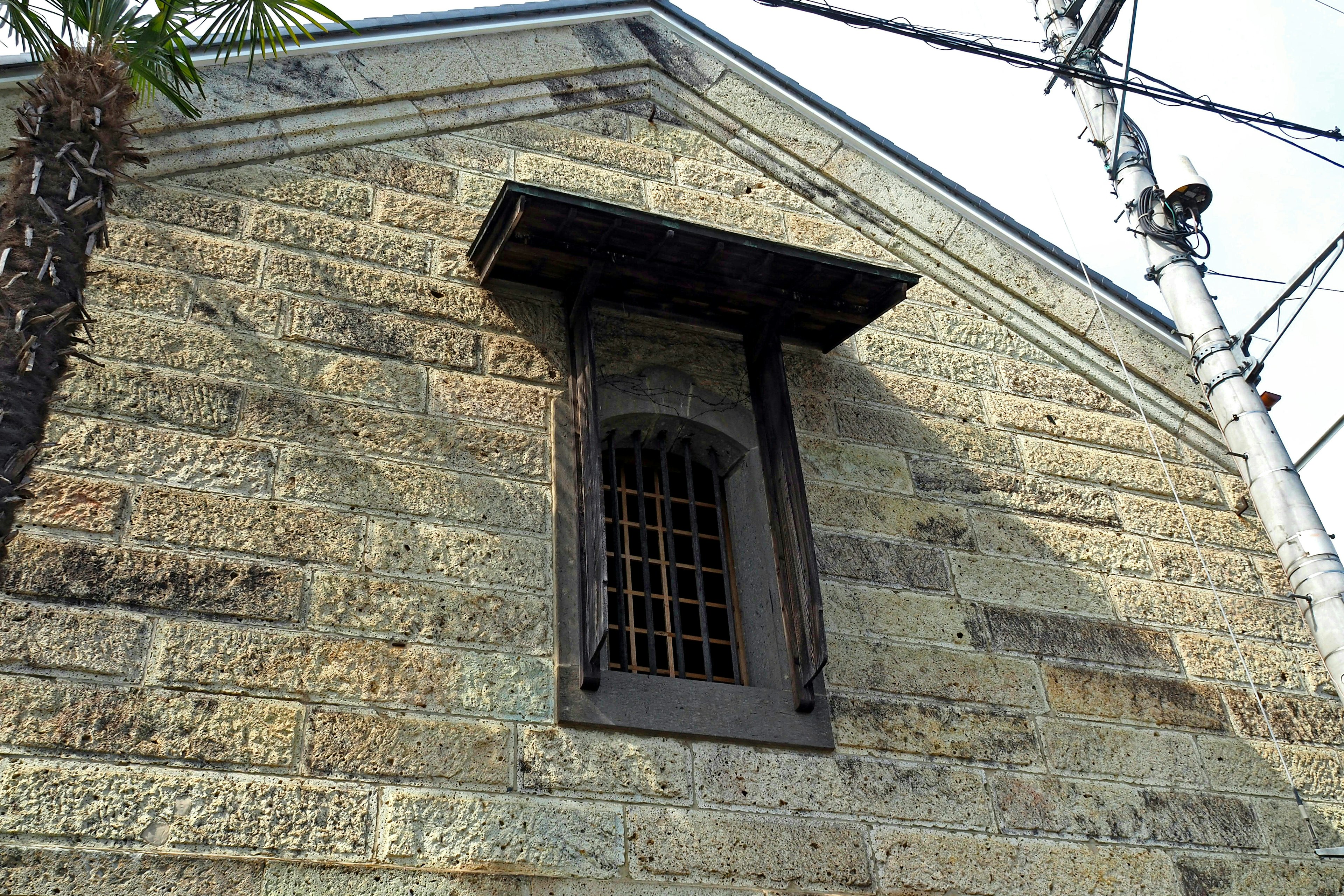 Window and roof section of an old stone building