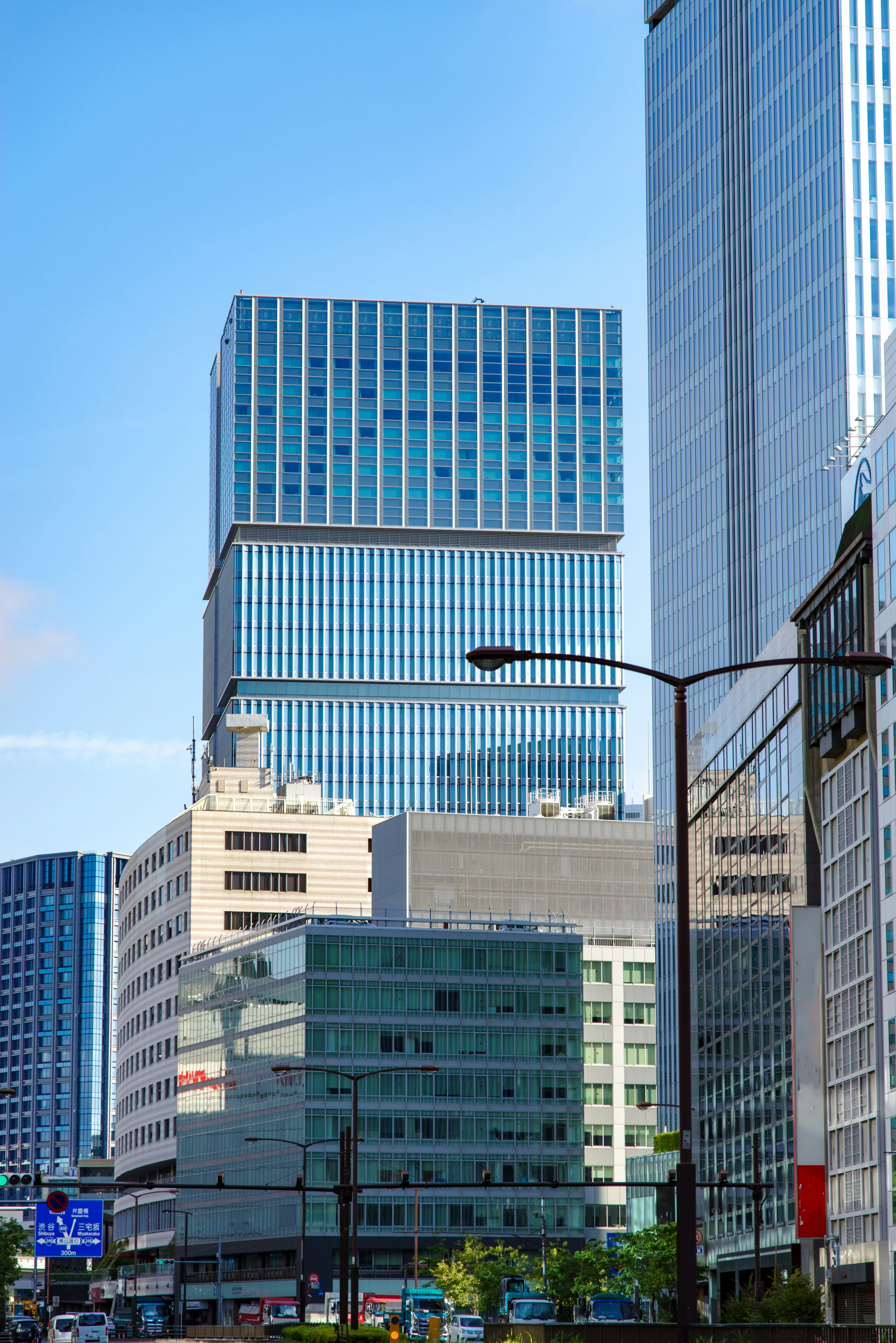 Modern cityscape featuring tall buildings under a blue sky