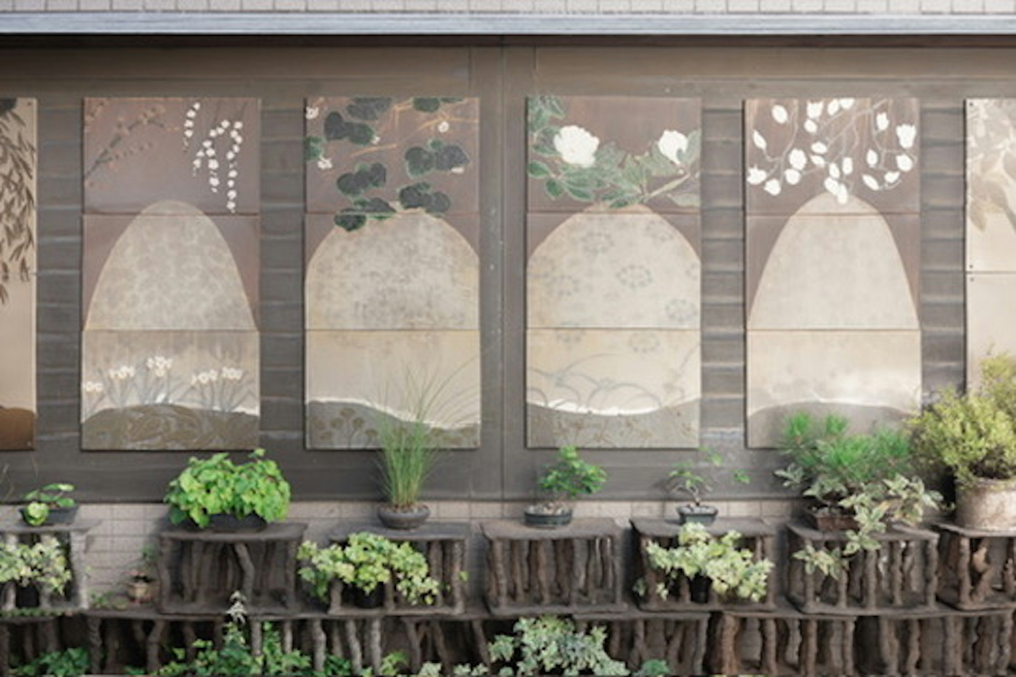 Decorative wall panels featuring nature motifs with potted plants