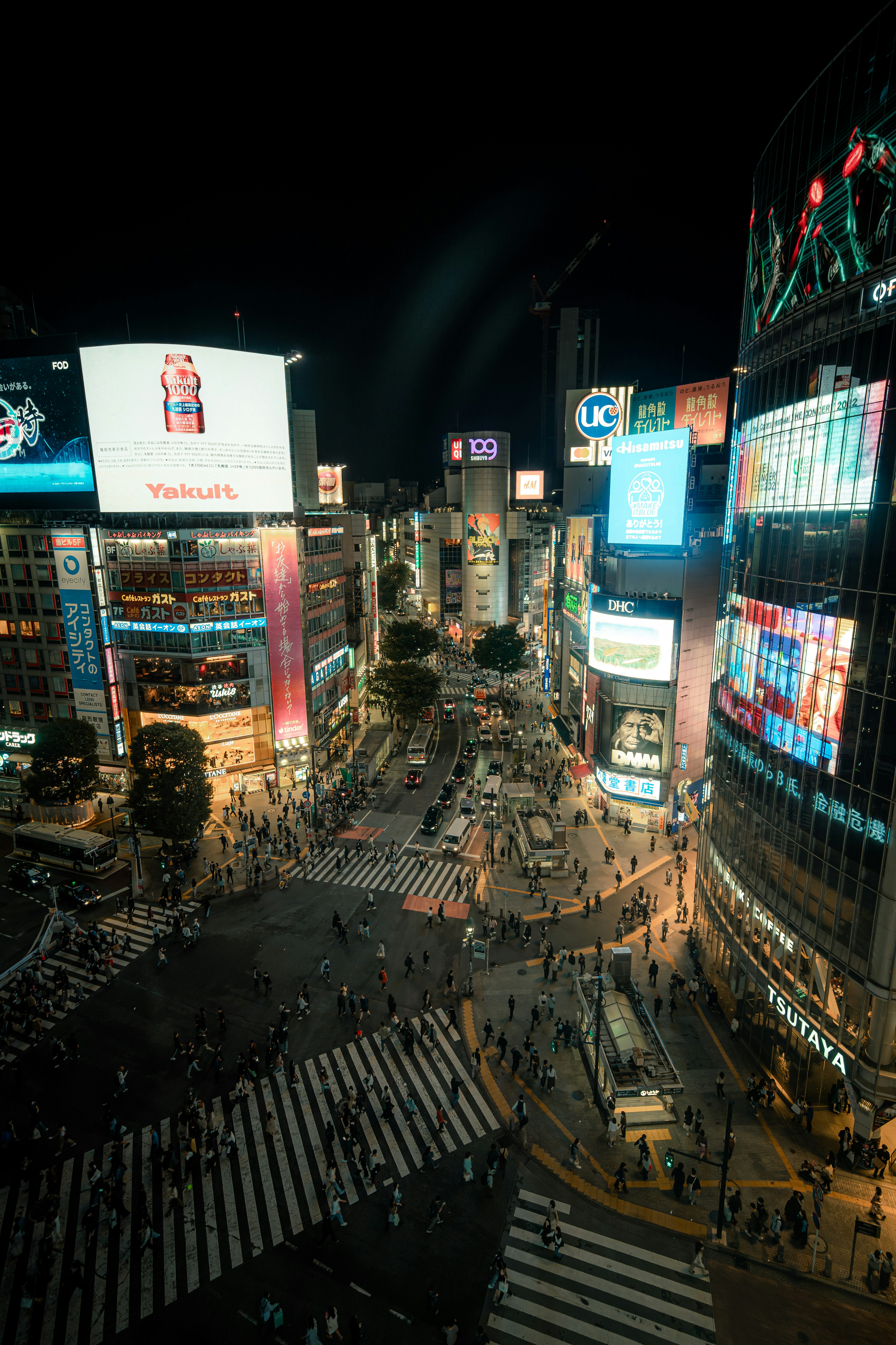 Shibuya Crossing at night with bright neon billboards