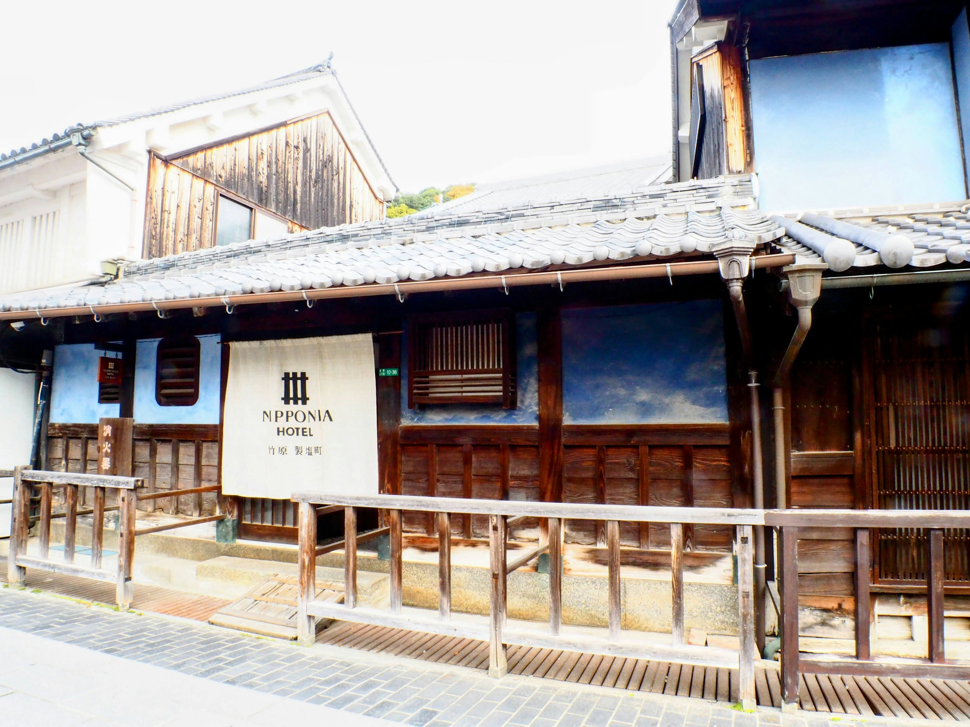 Traditional wooden building exterior featuring blue walls and a wooden deck