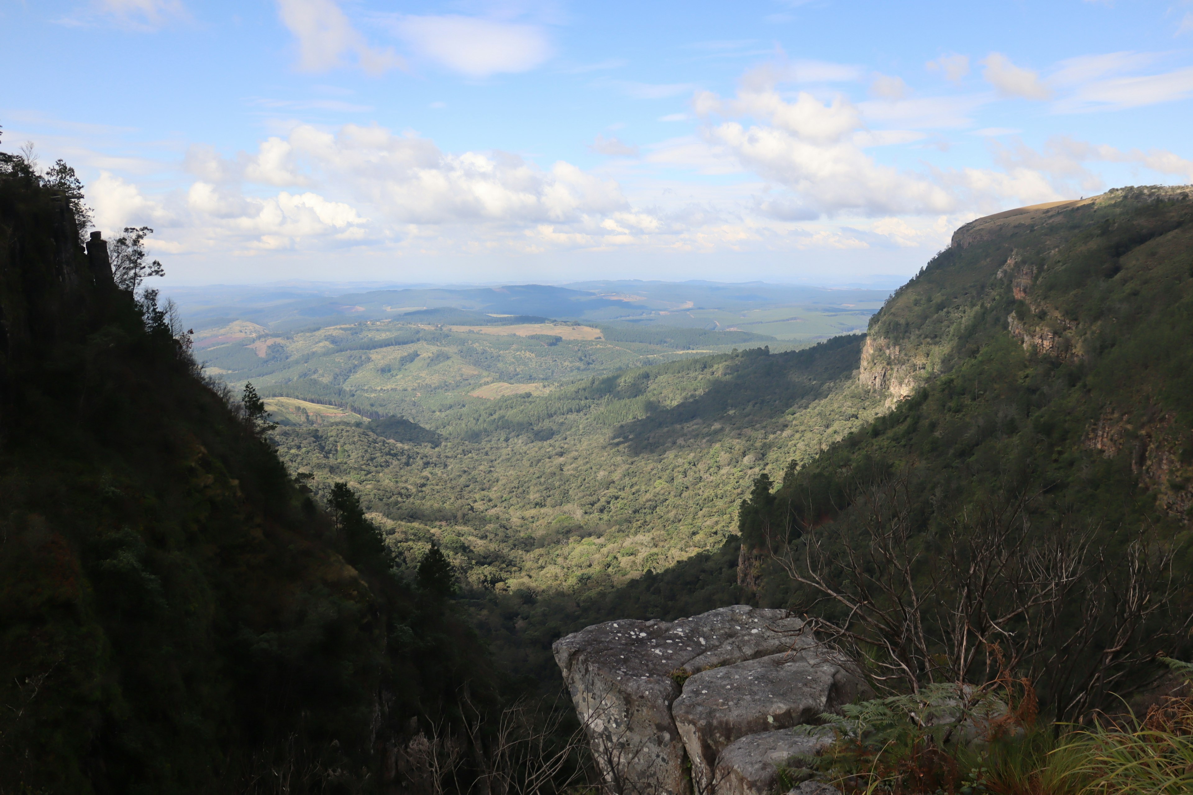 Vast mountain landscape with a blue sky and deep valley