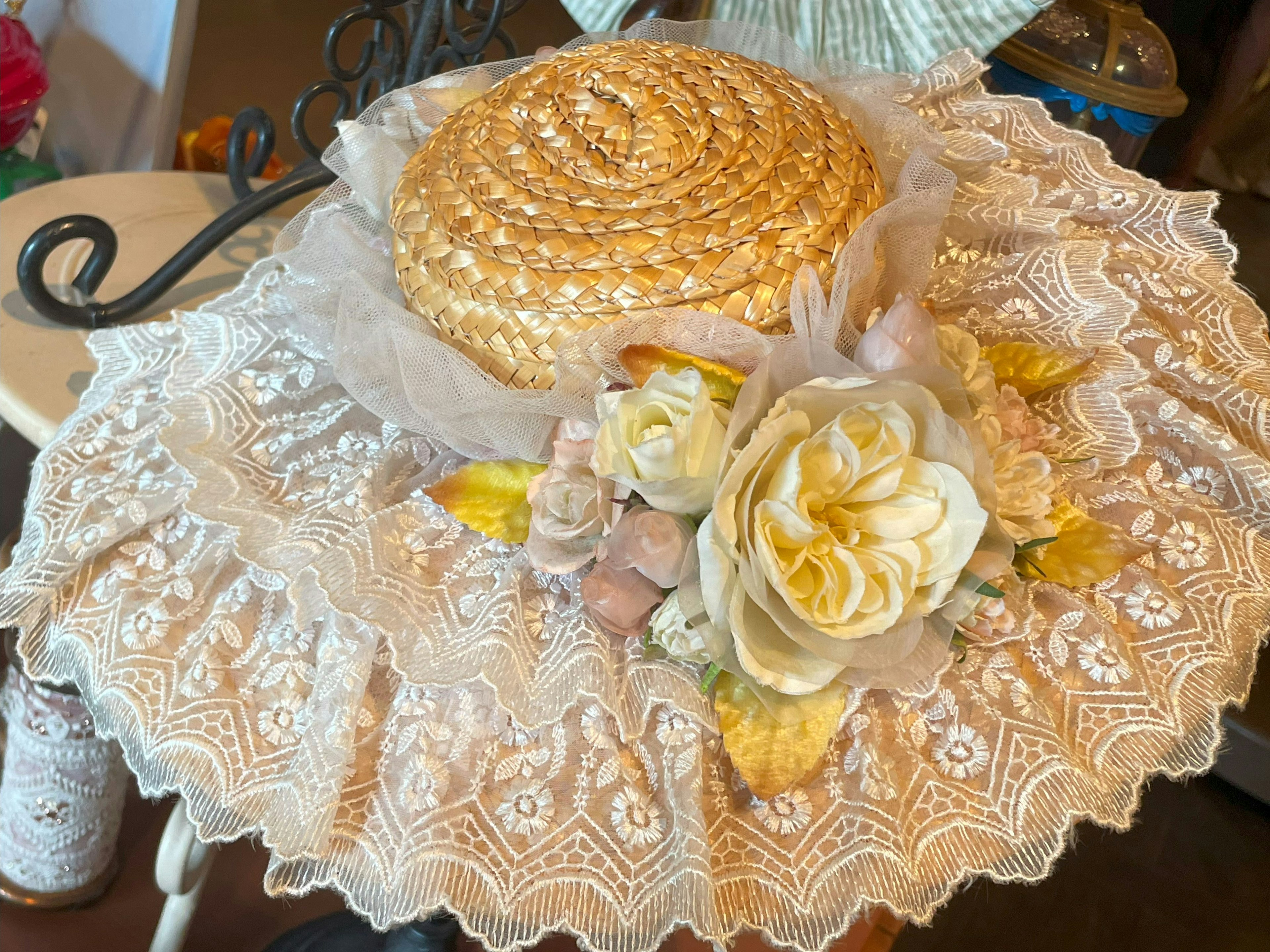 Straw hat with lace and floral decorations