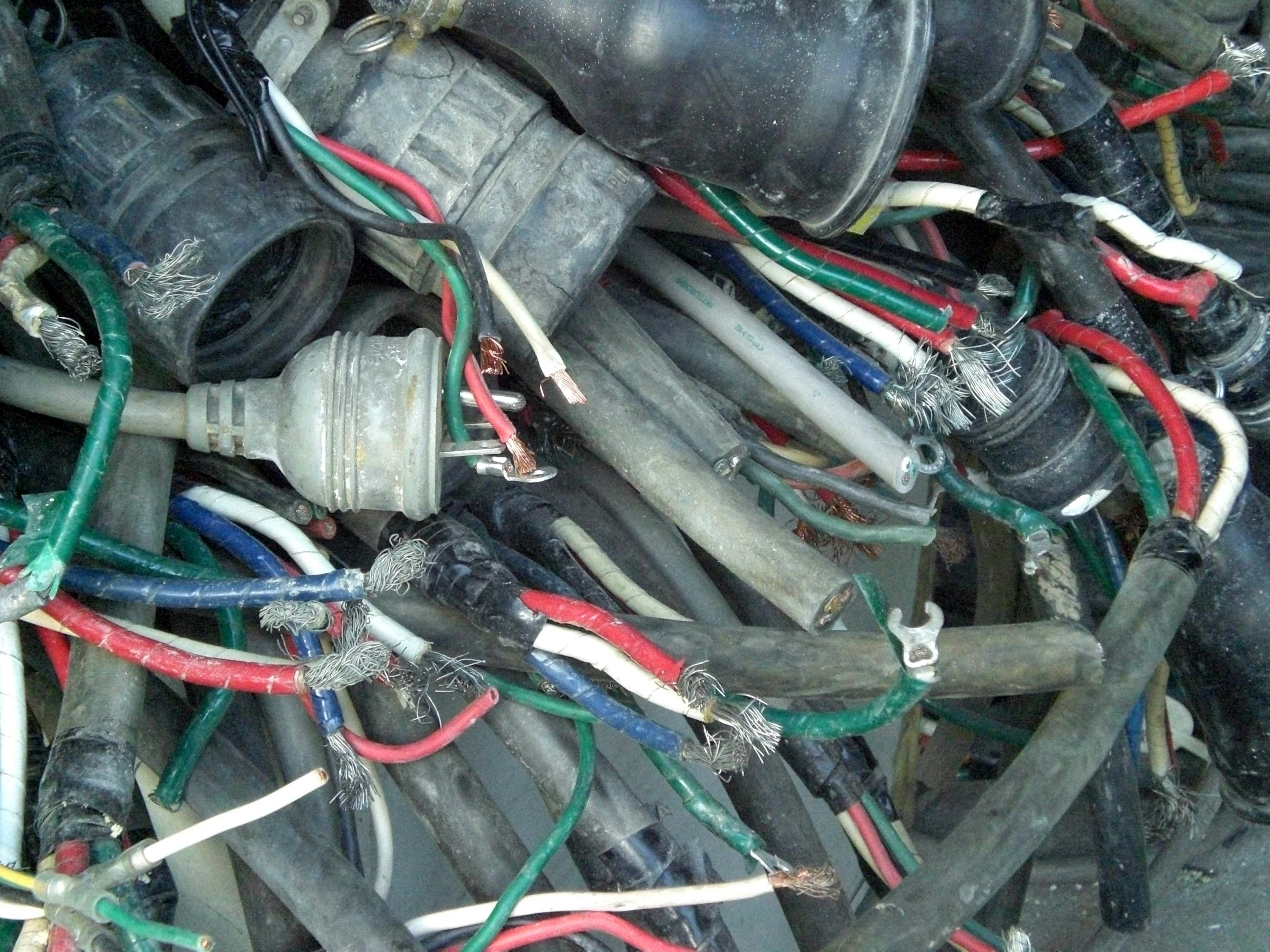 Tumpukan kabel dan konektor yang kacau terlihat dalam gambar