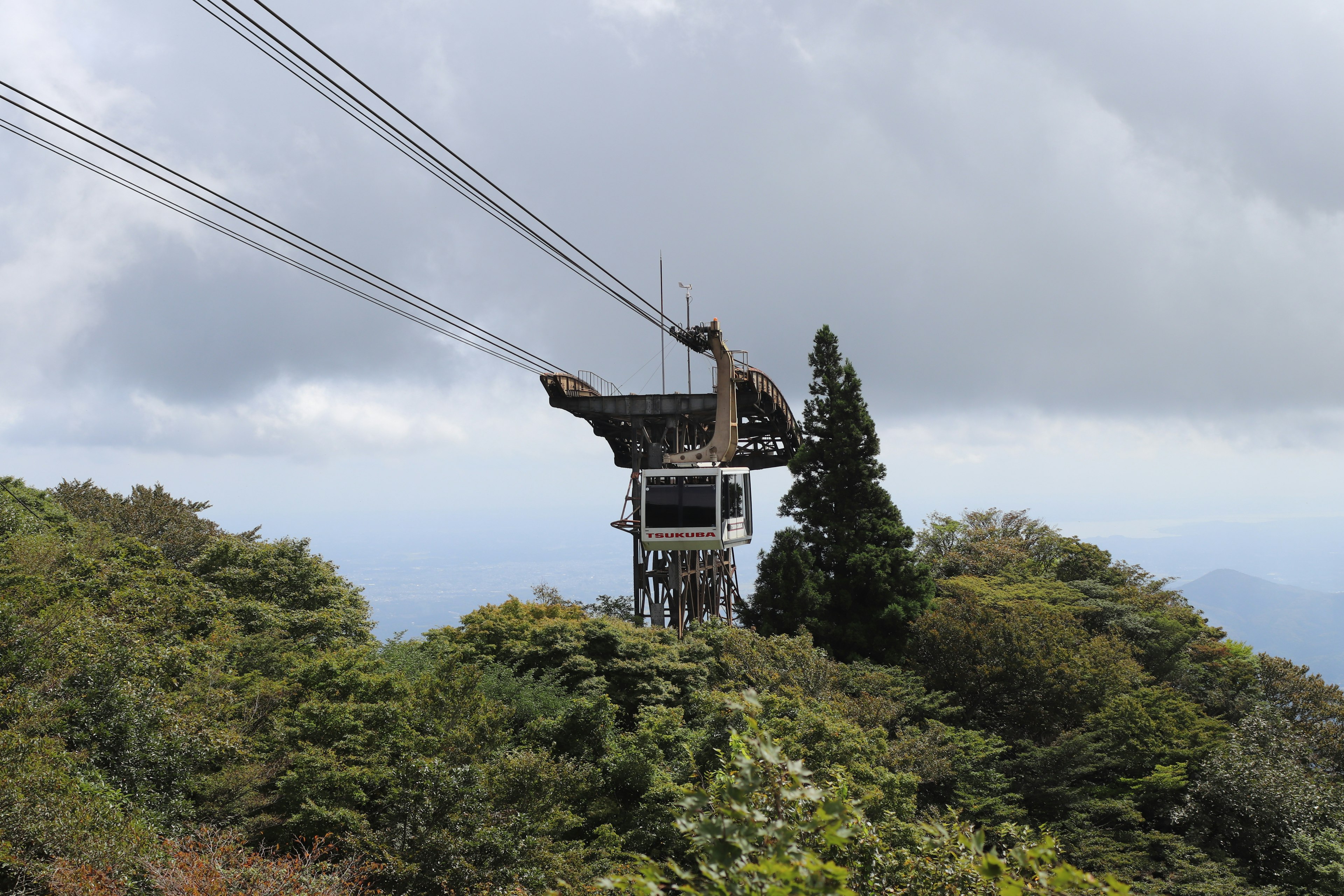 Une station de téléphérique sur une montagne entourée d'arbres verts