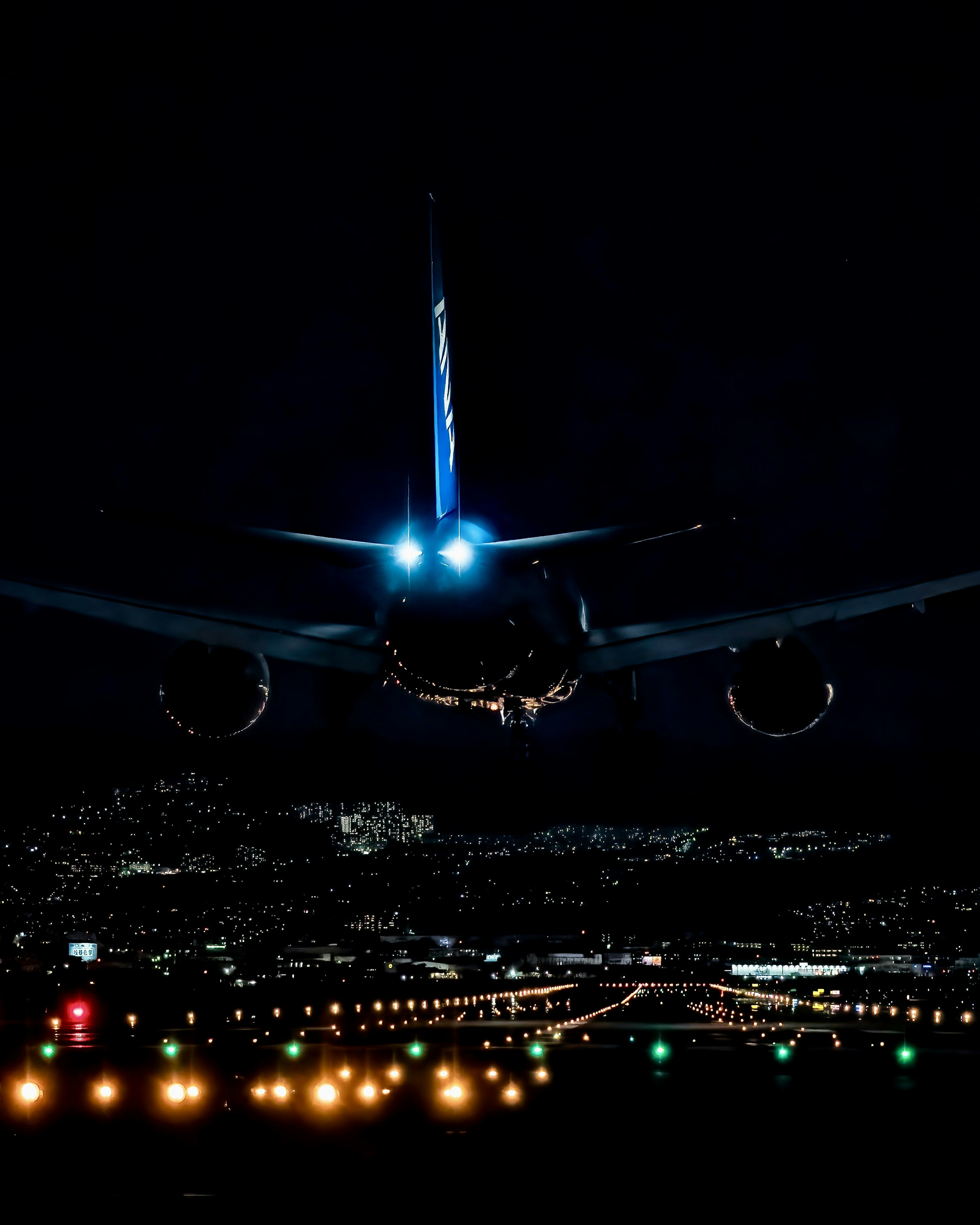 Airplane landing at night with runway lights