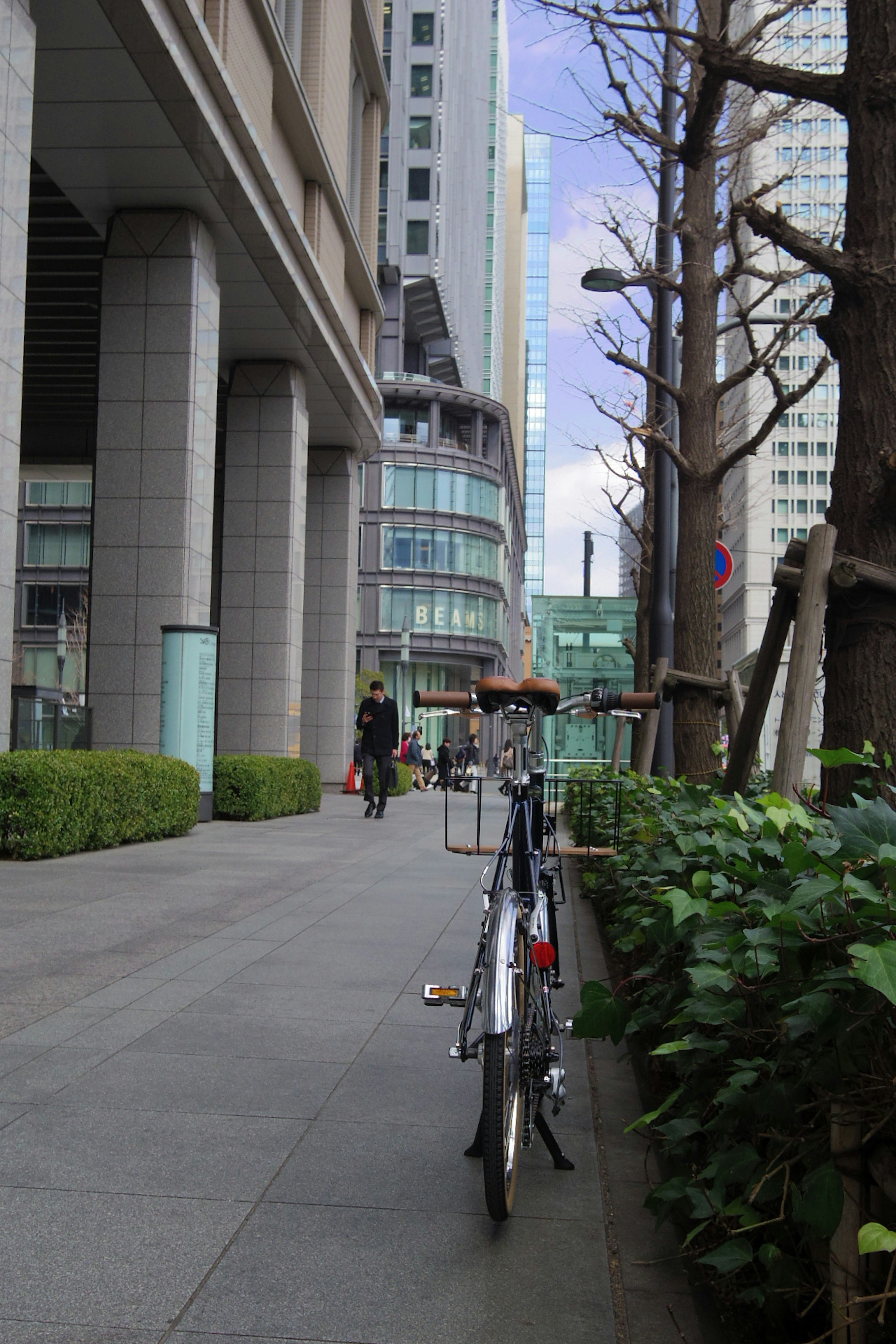 Bicycle parked on a city street with skyscrapers in the background