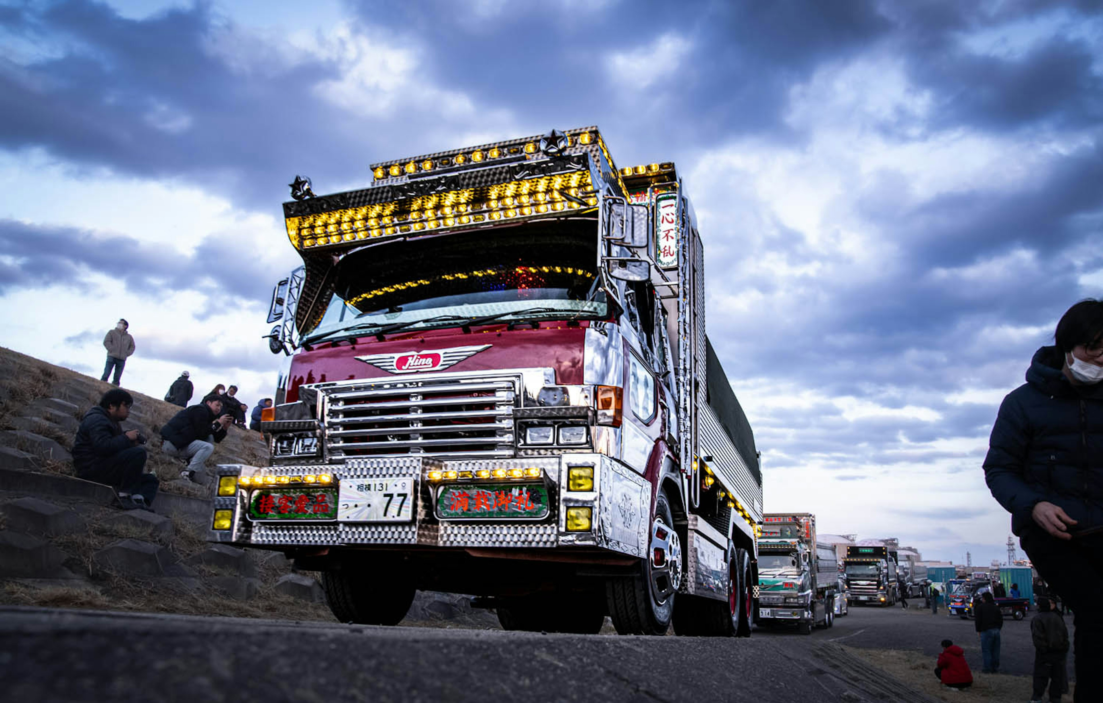 Decoratively designed truck driving against a cloudy sky