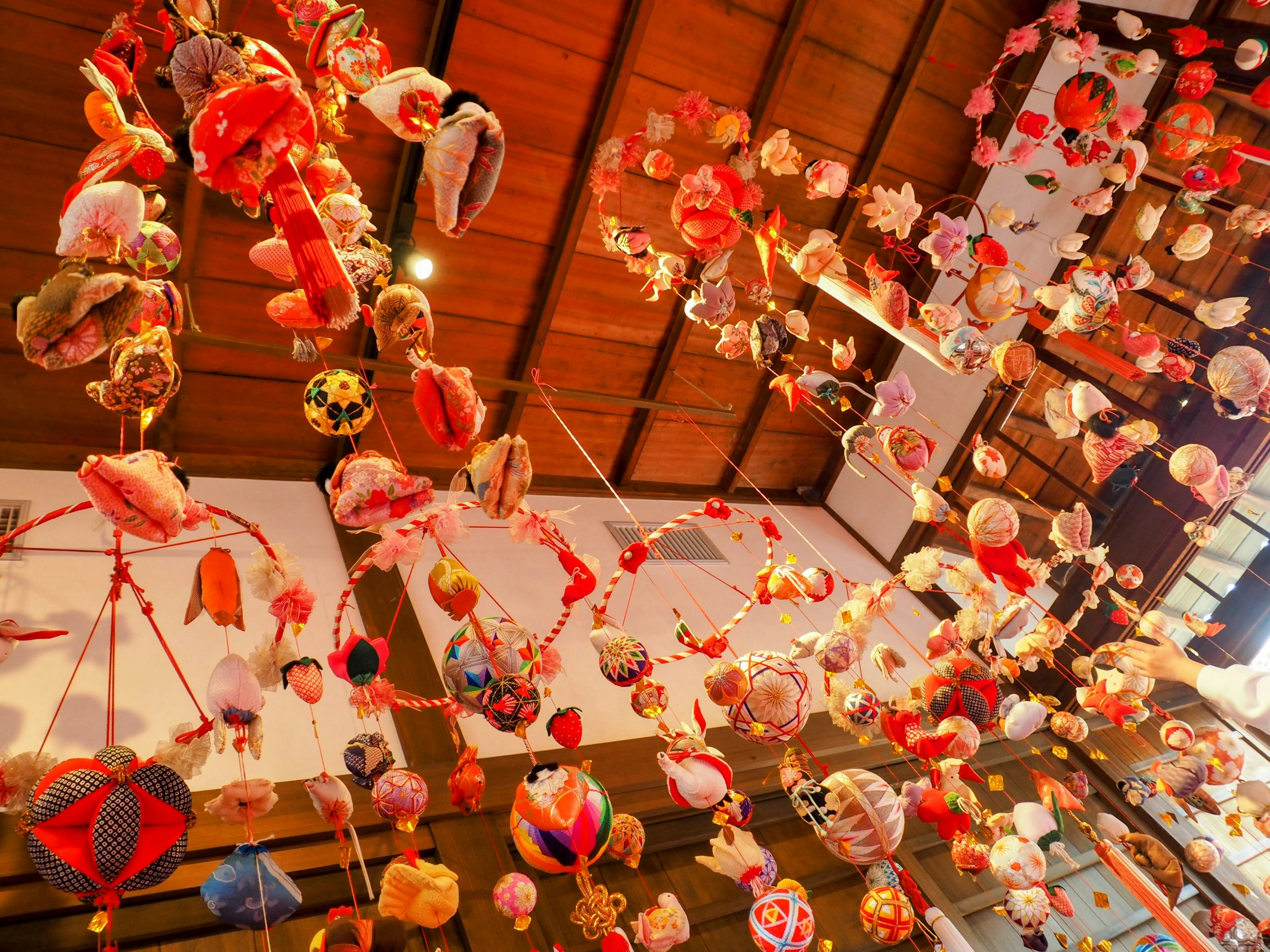 Colorful hanging decorations suspended from the ceiling in a vibrant space