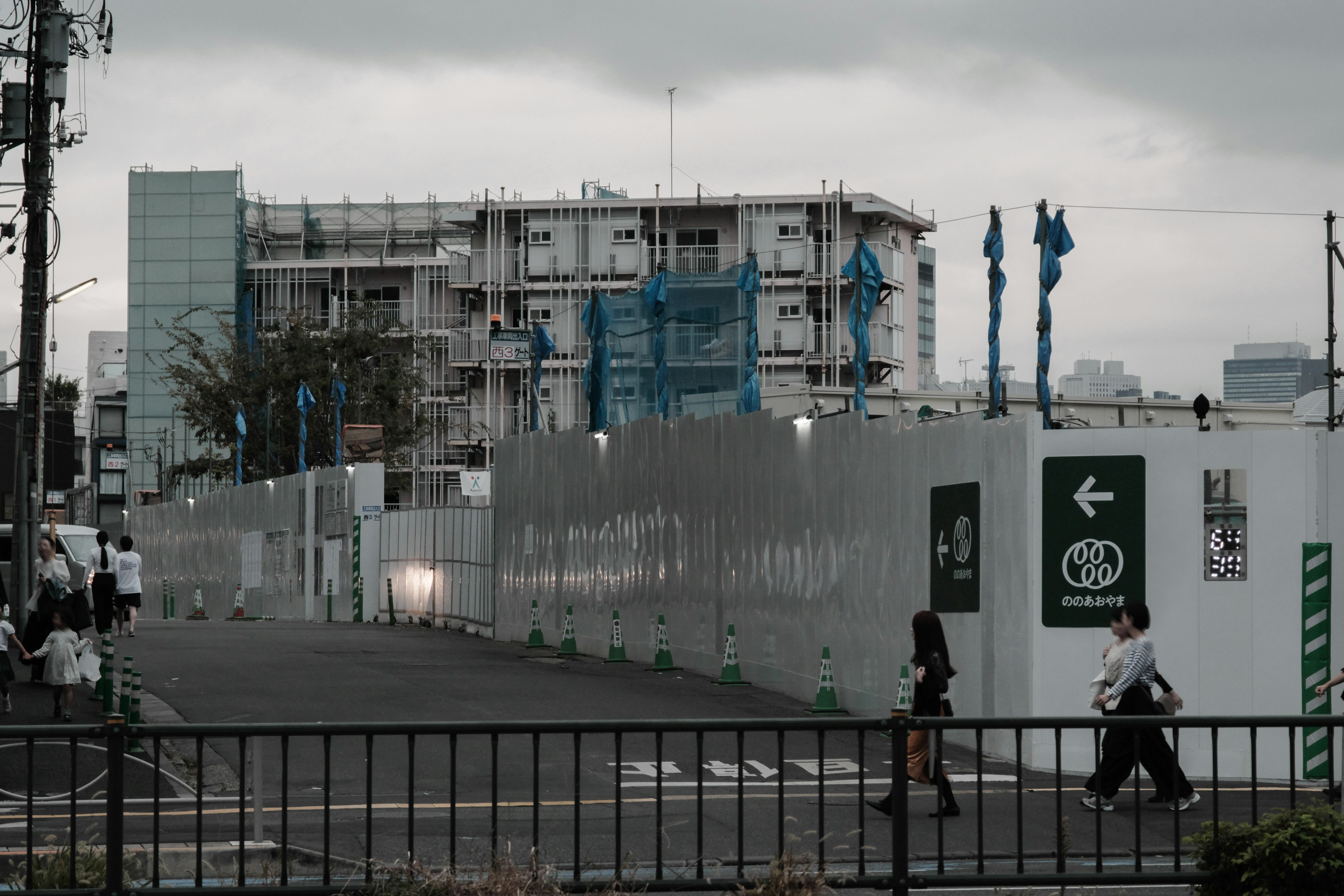 Construction site featuring a building under construction and blue flags