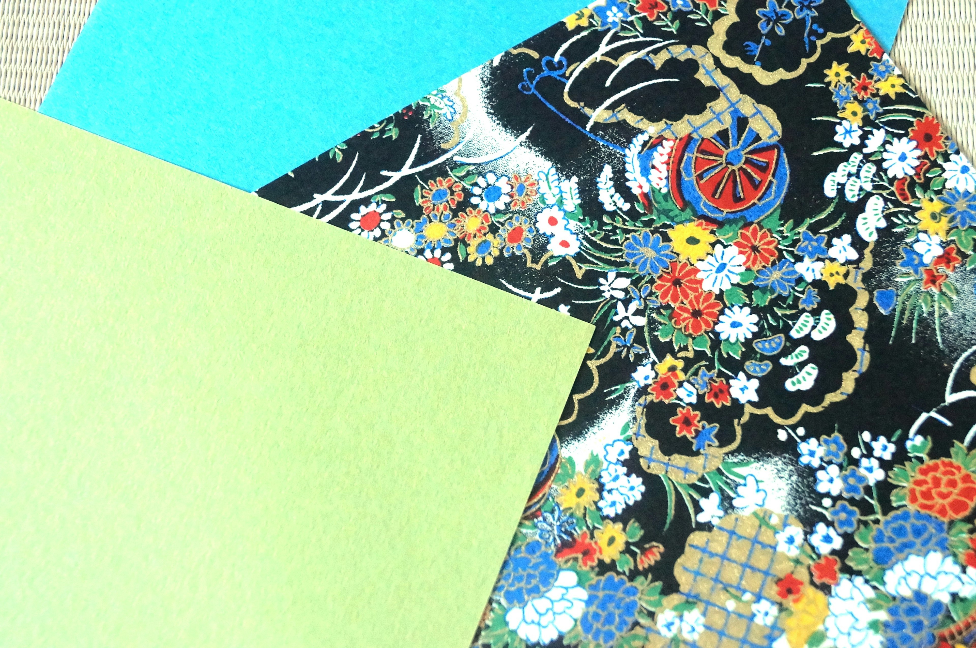 Colorful Japanese patterned paper alongside solid blue and green sheets