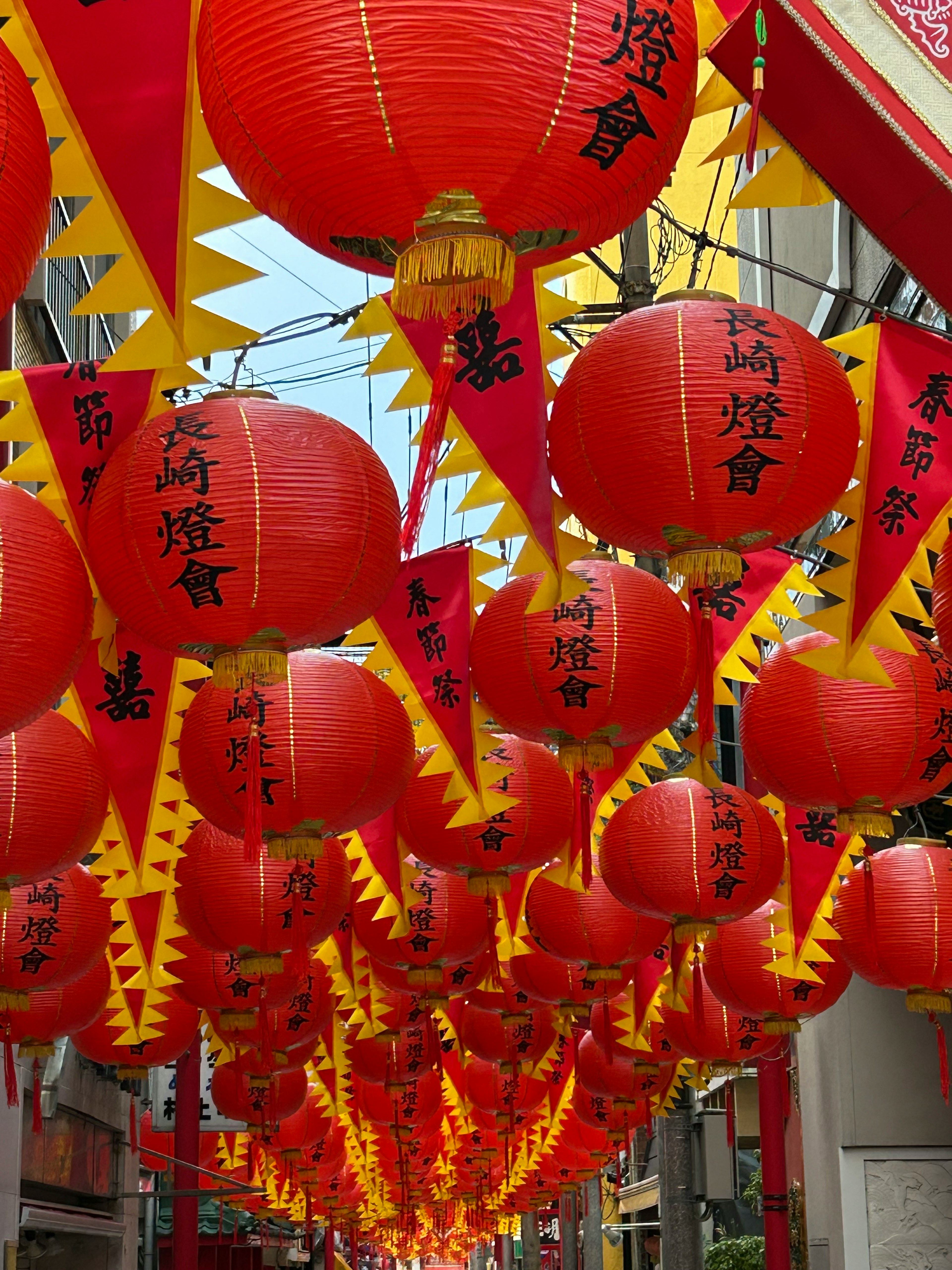 Street adorned with red lanterns and yellow flags