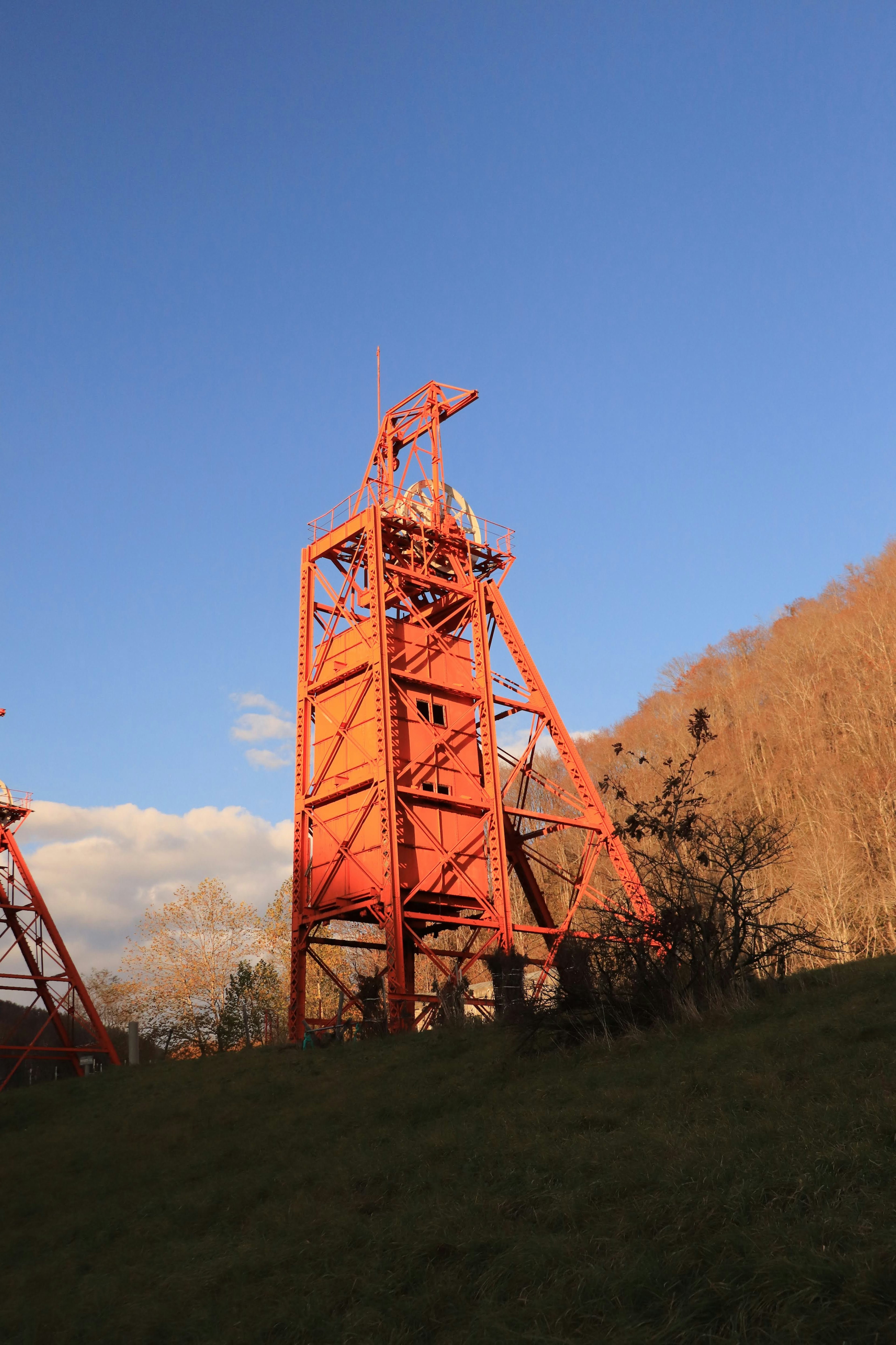 Red tower against a blue sky with surrounding nature