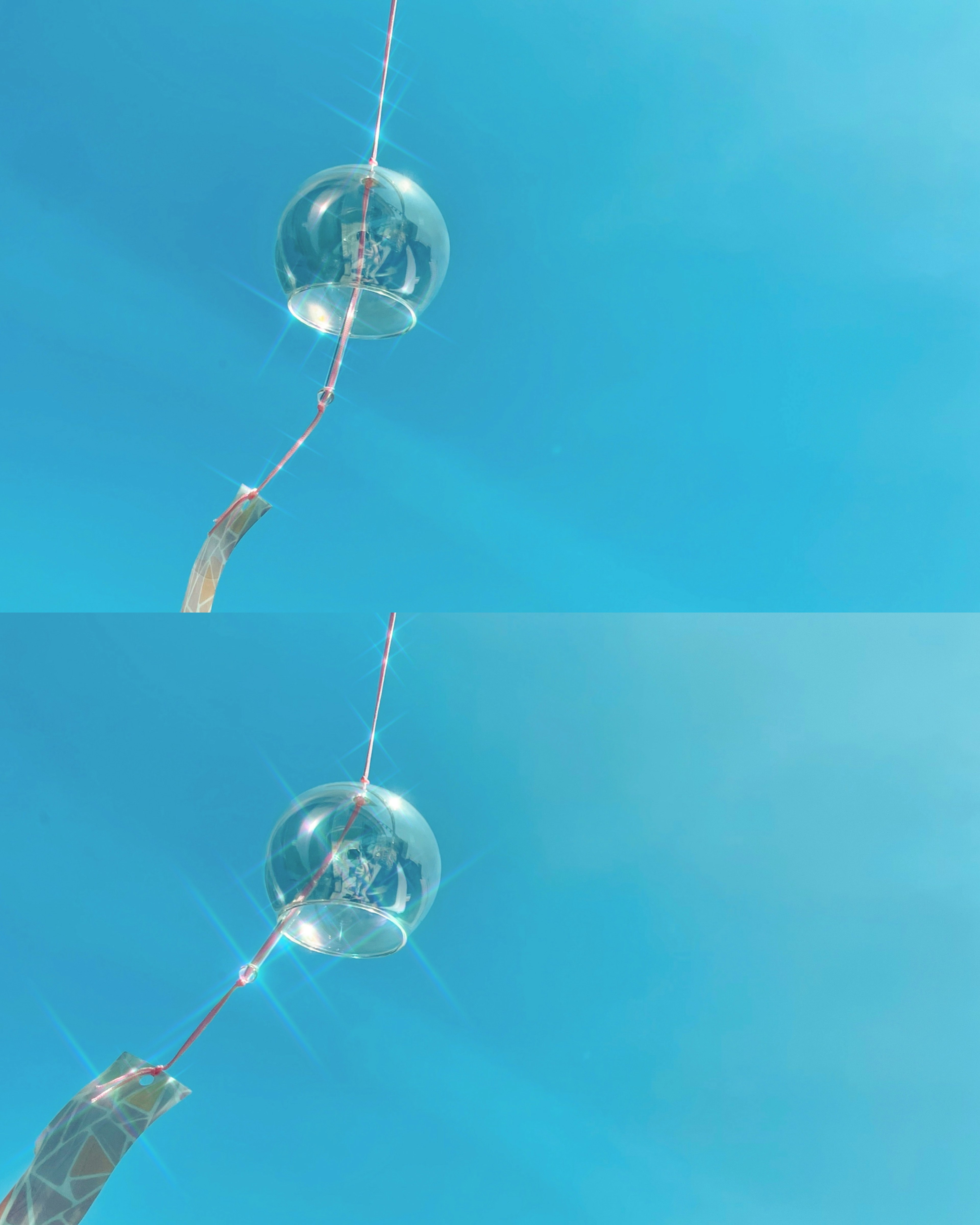 Transparent spherical object suspended against a blue sky