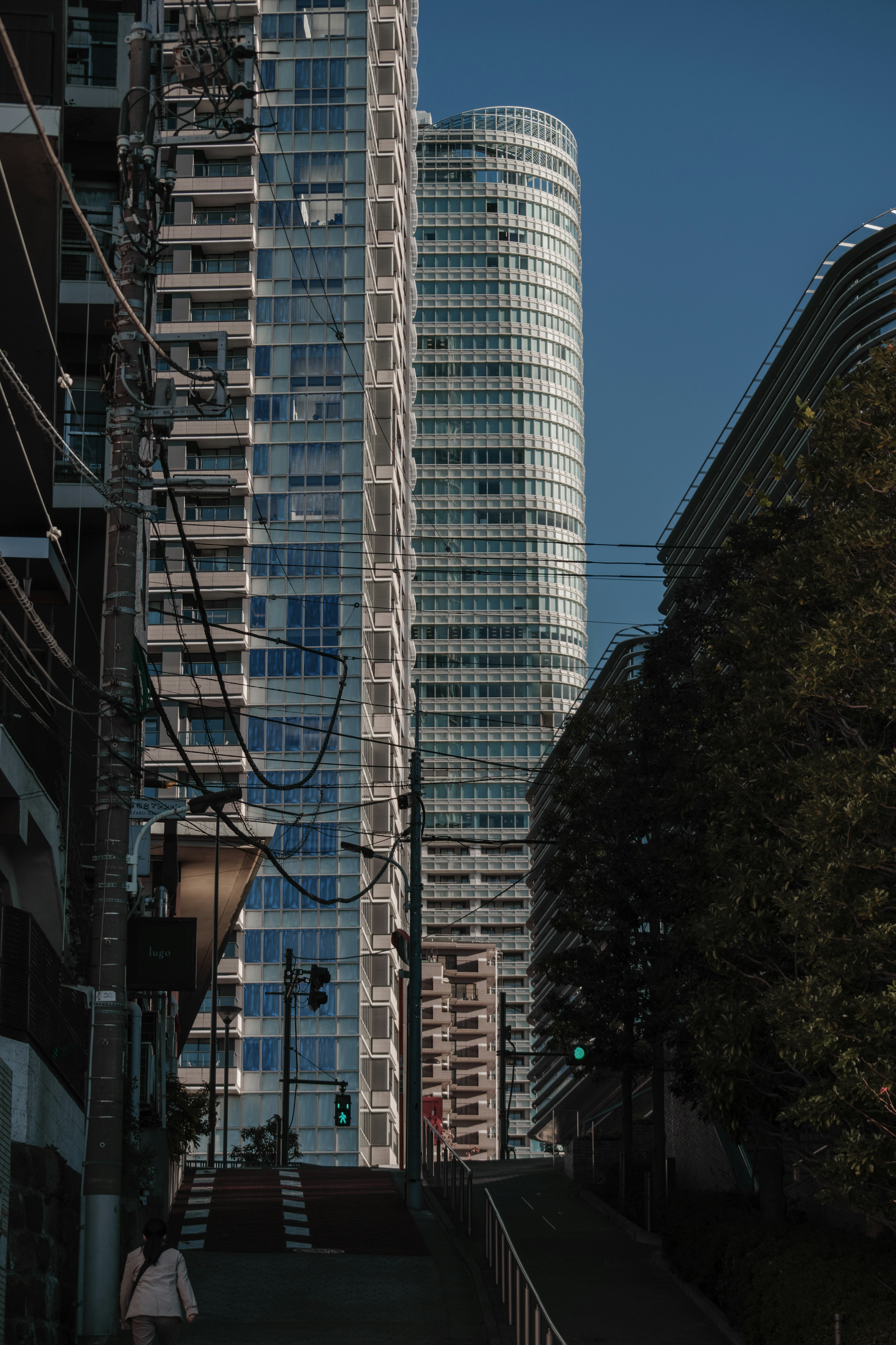 Cityscape featuring tall buildings with glass facades under a clear blue sky