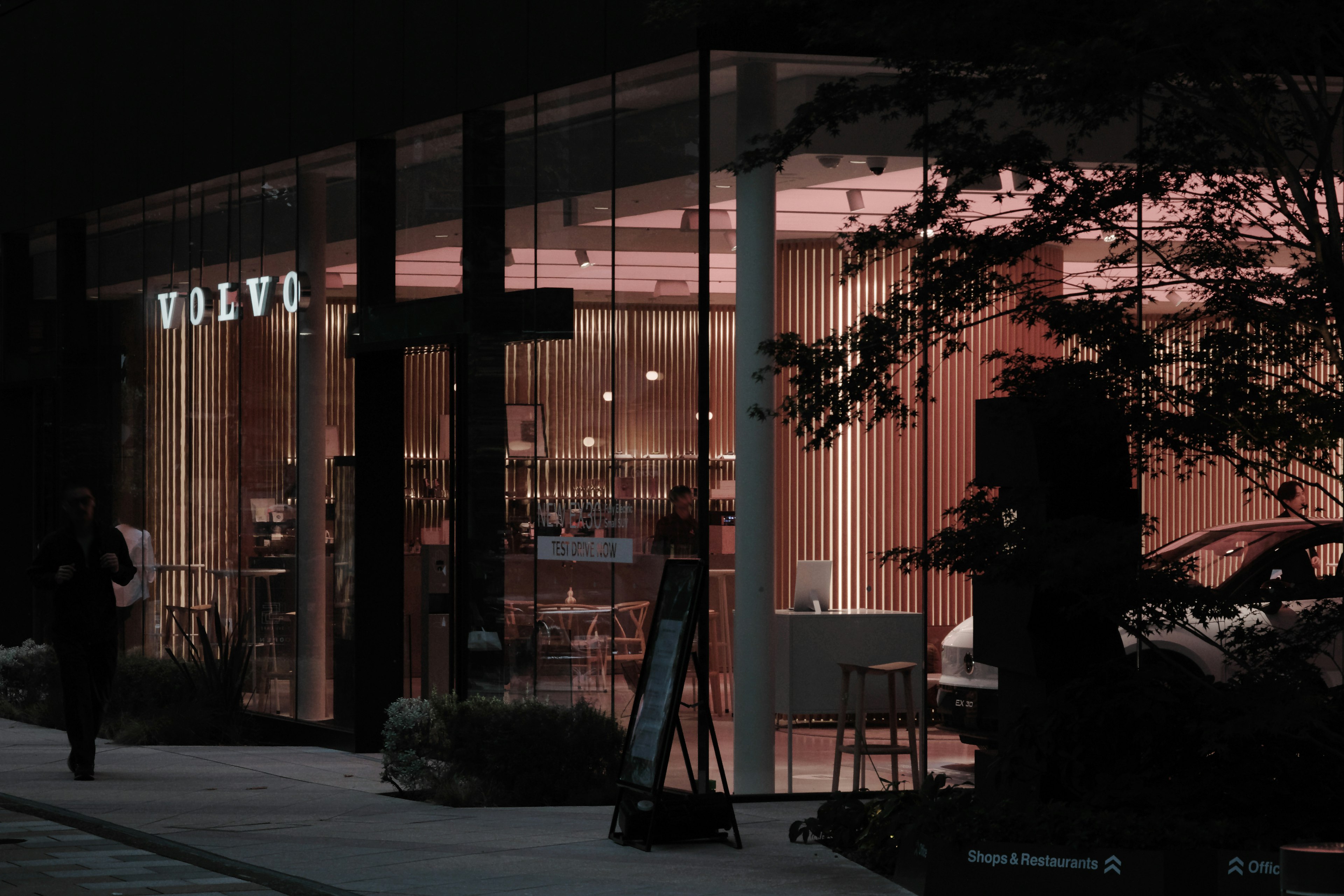 Volvo's modern showroom illuminated at night