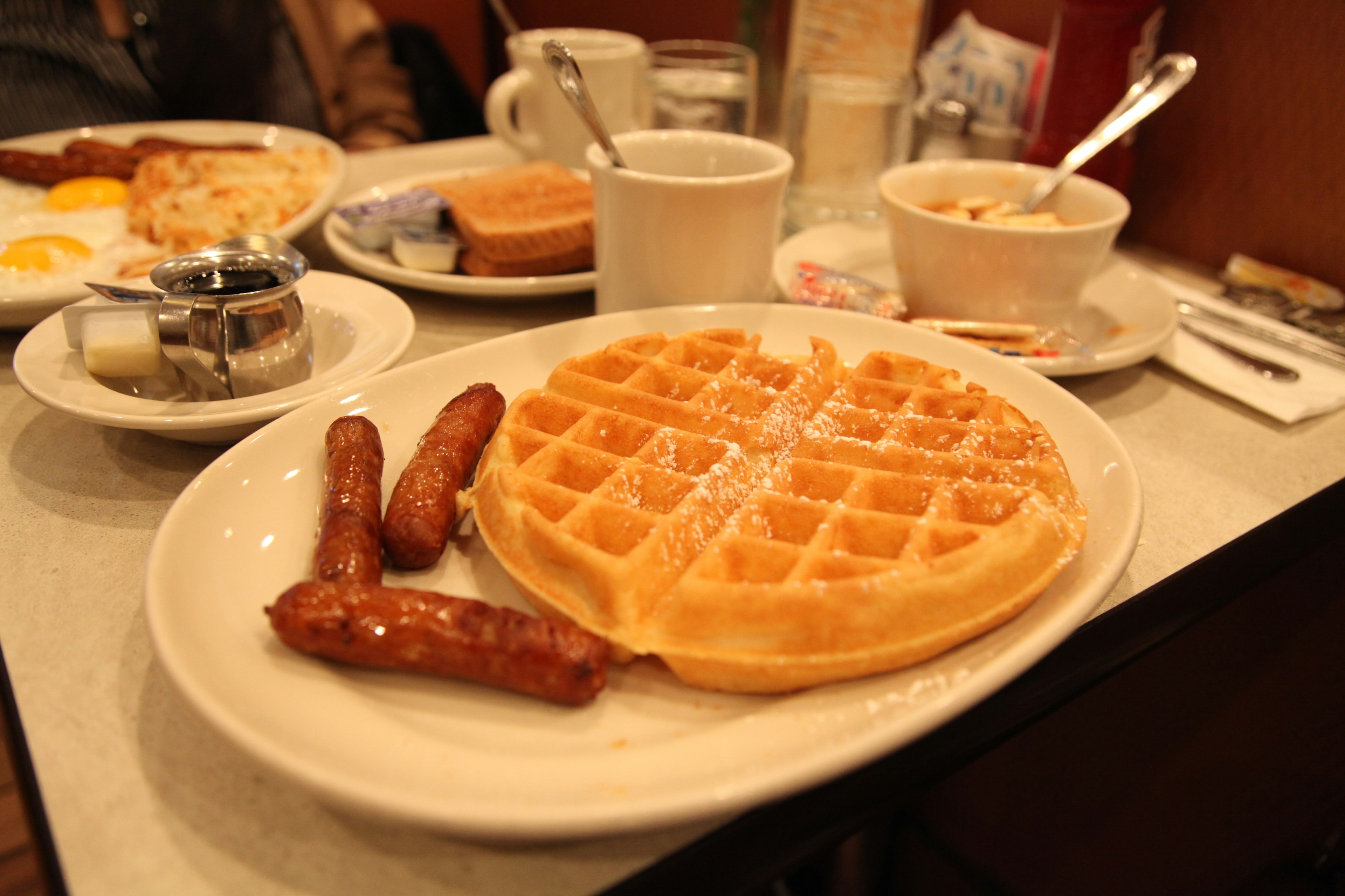 Plate of breakfast waffles and sausages