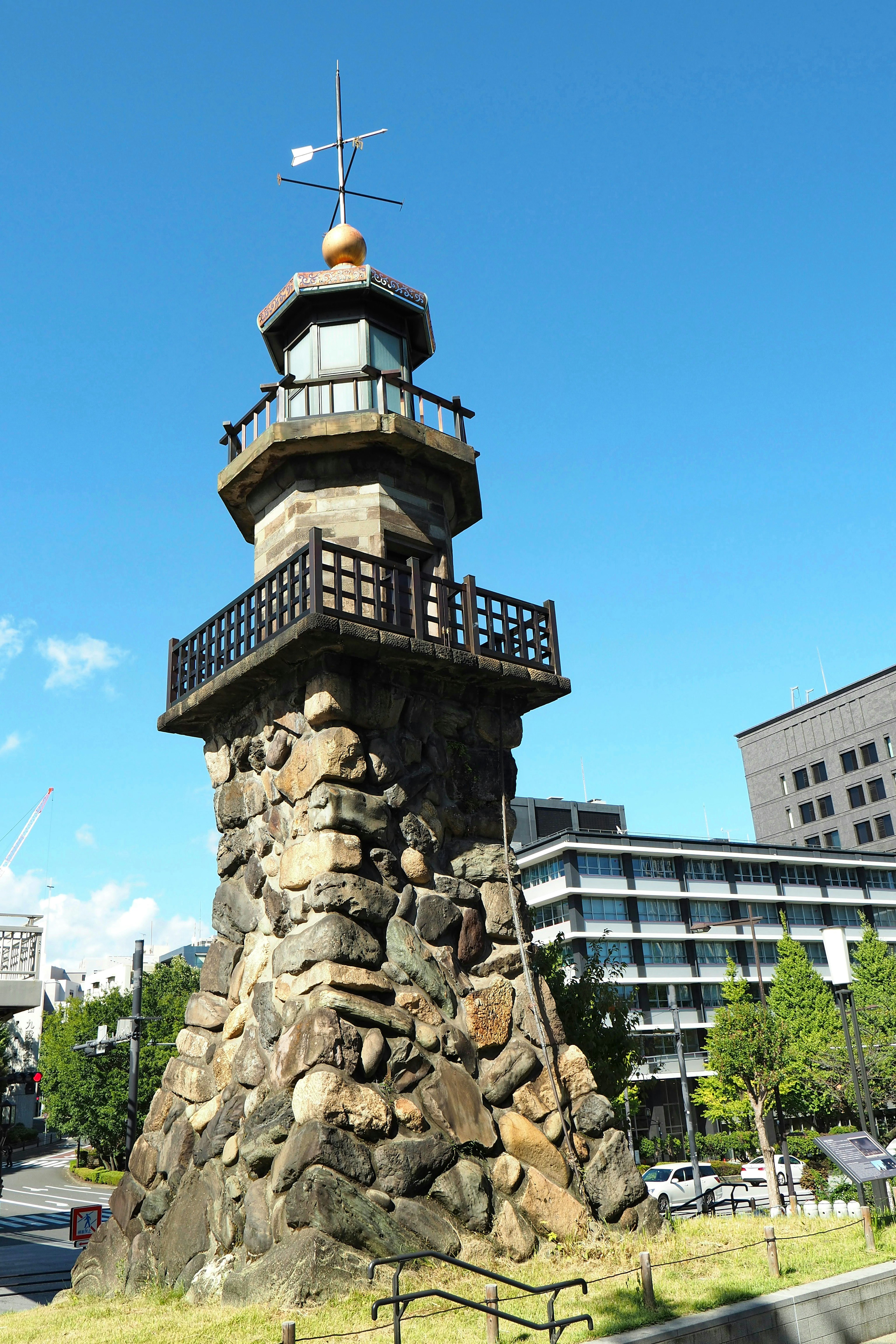 Stone lighthouse standing under a blue sky