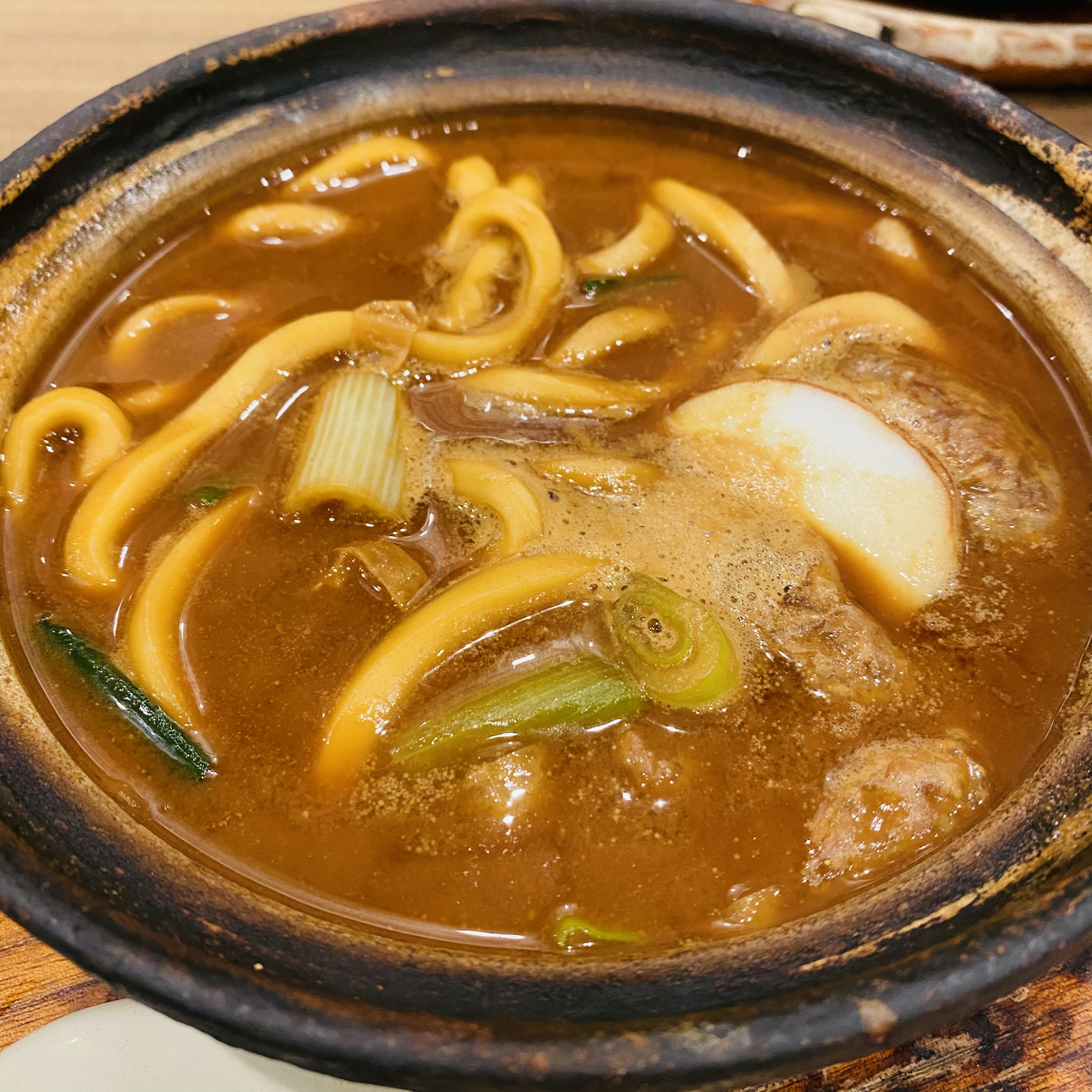 鍋で煮込まれたうどんと具材のスープ