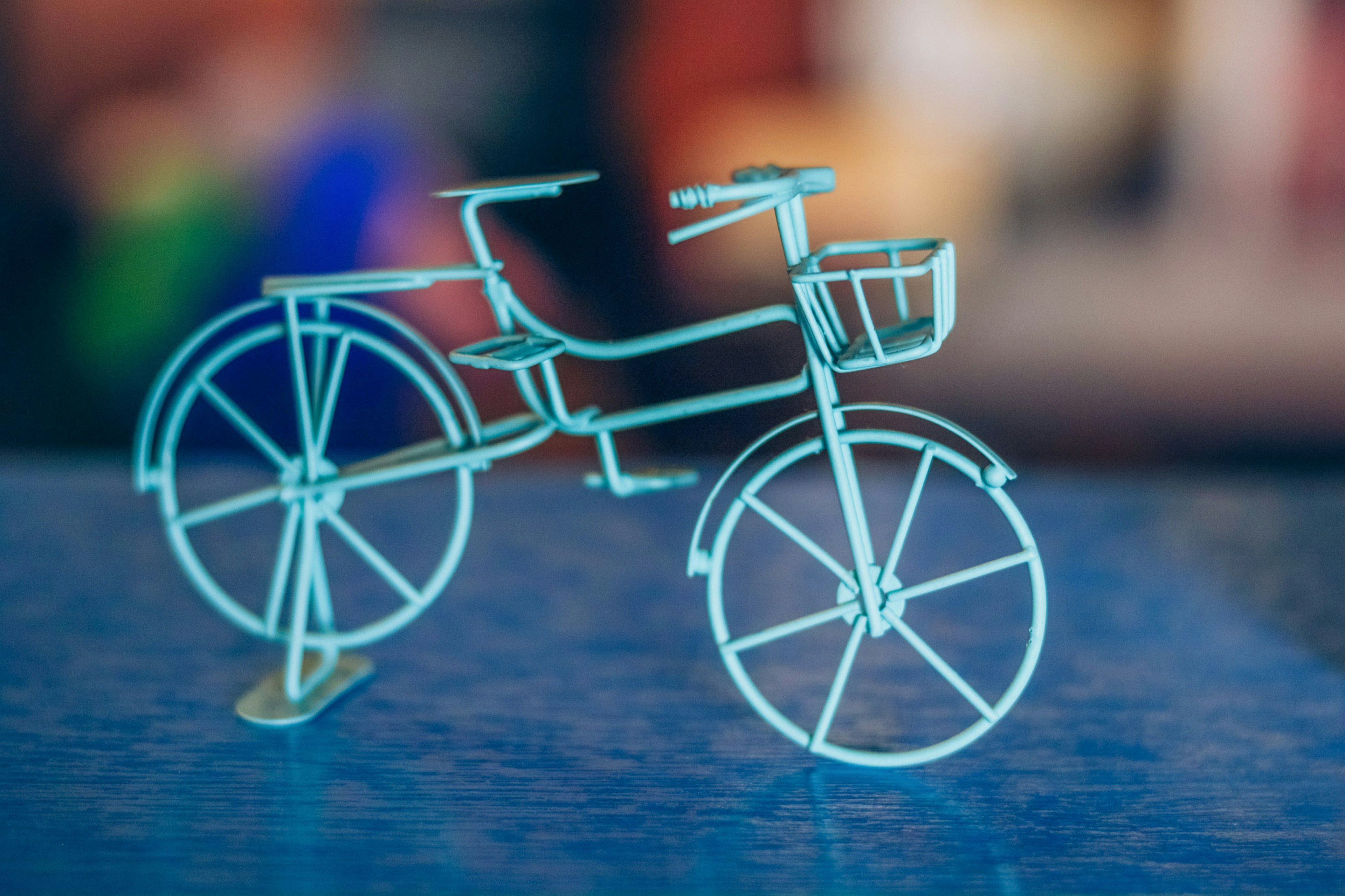 A blue metal bicycle model placed on a table