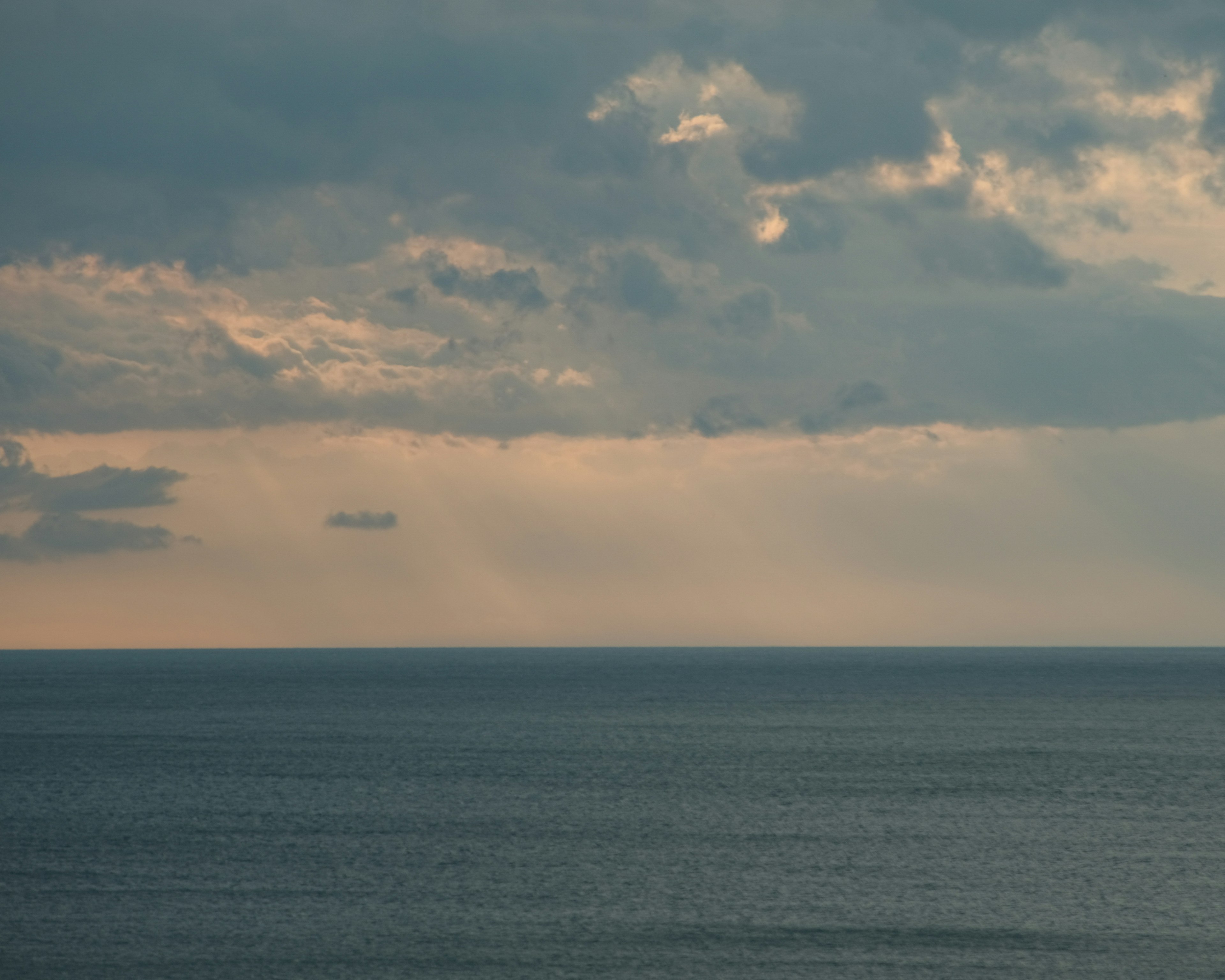 Seascape with clouds and soft light shining through