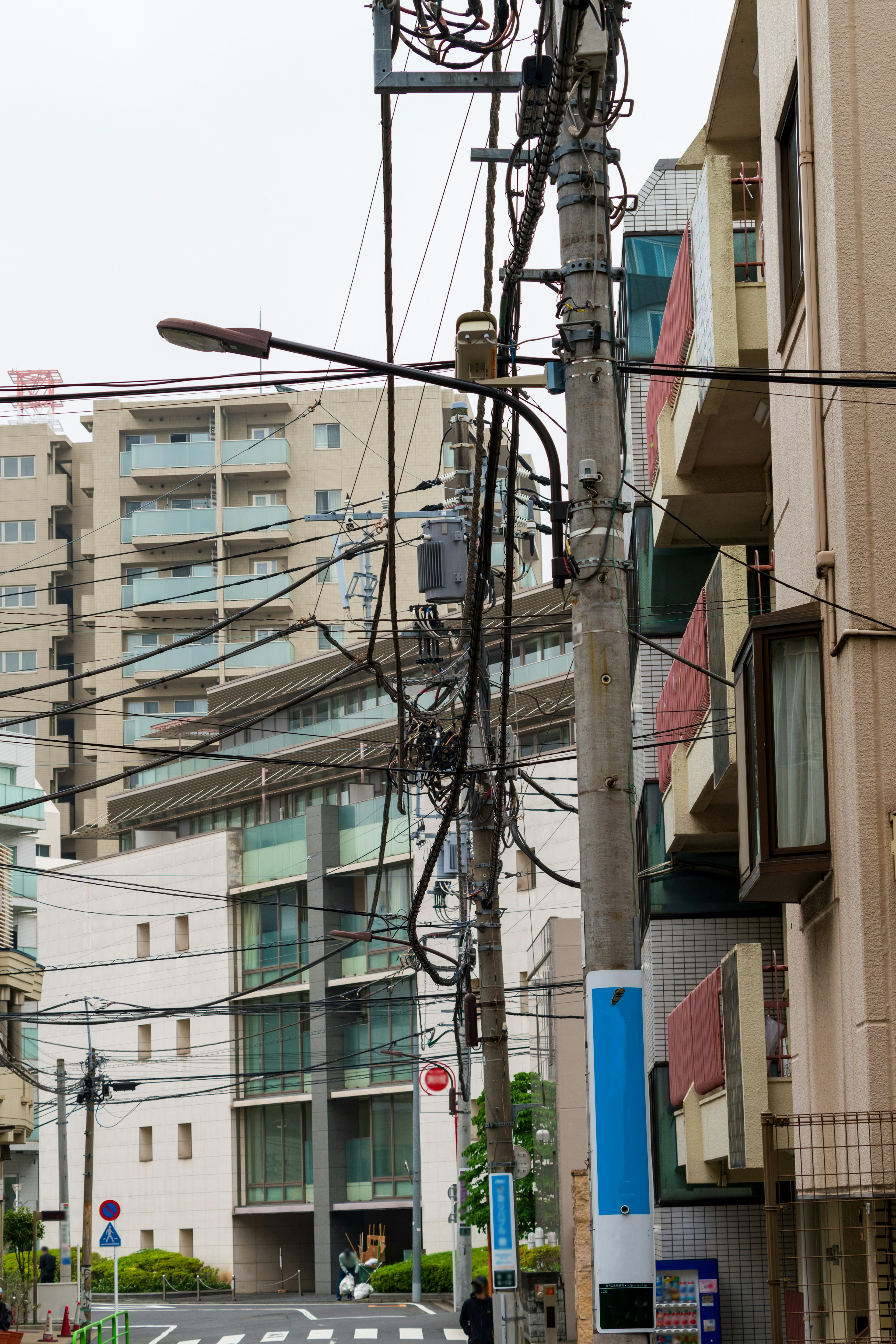 Urban street view featuring complex power lines and modern buildings