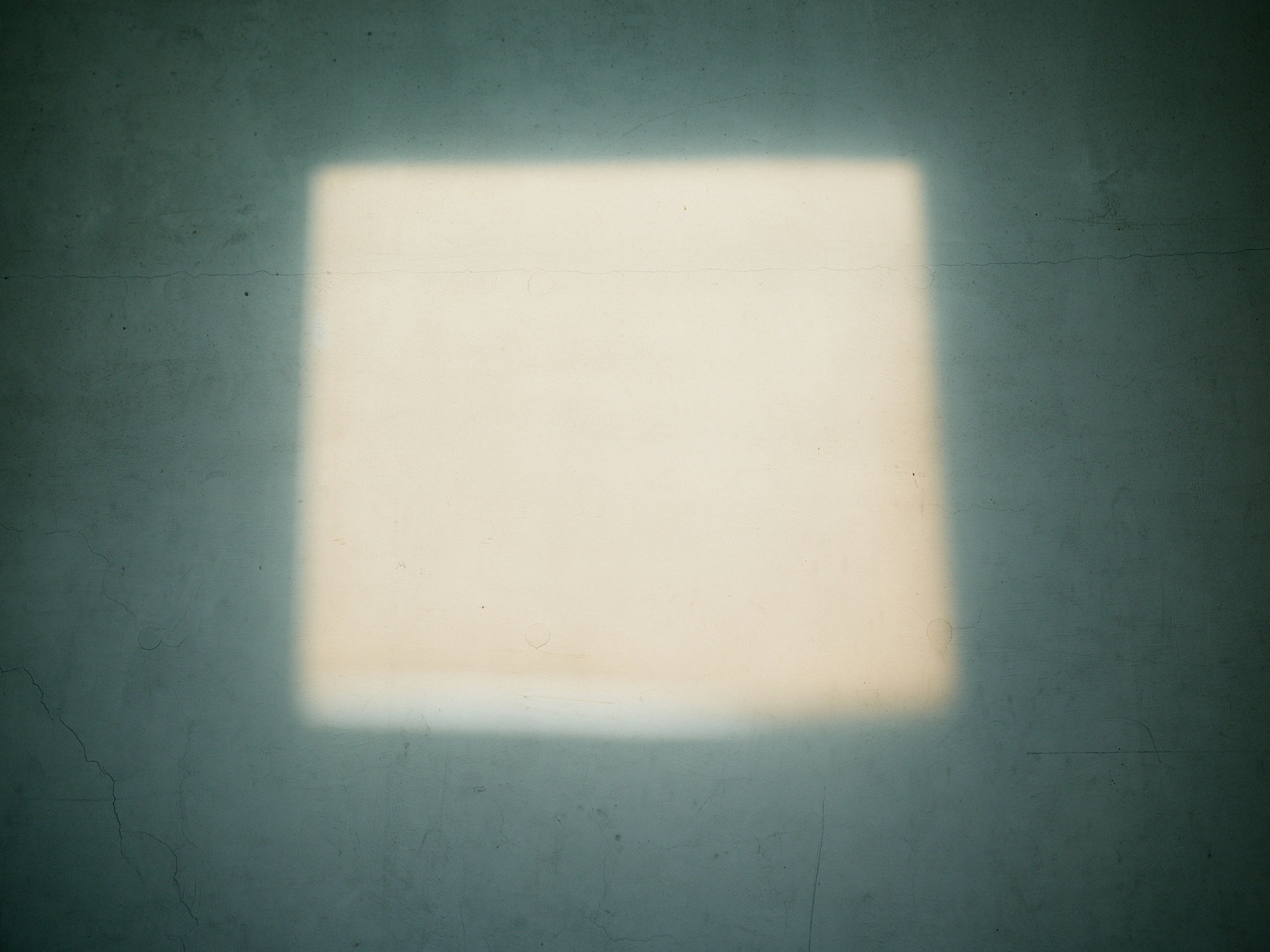 A blurred square light spot in the center of the image