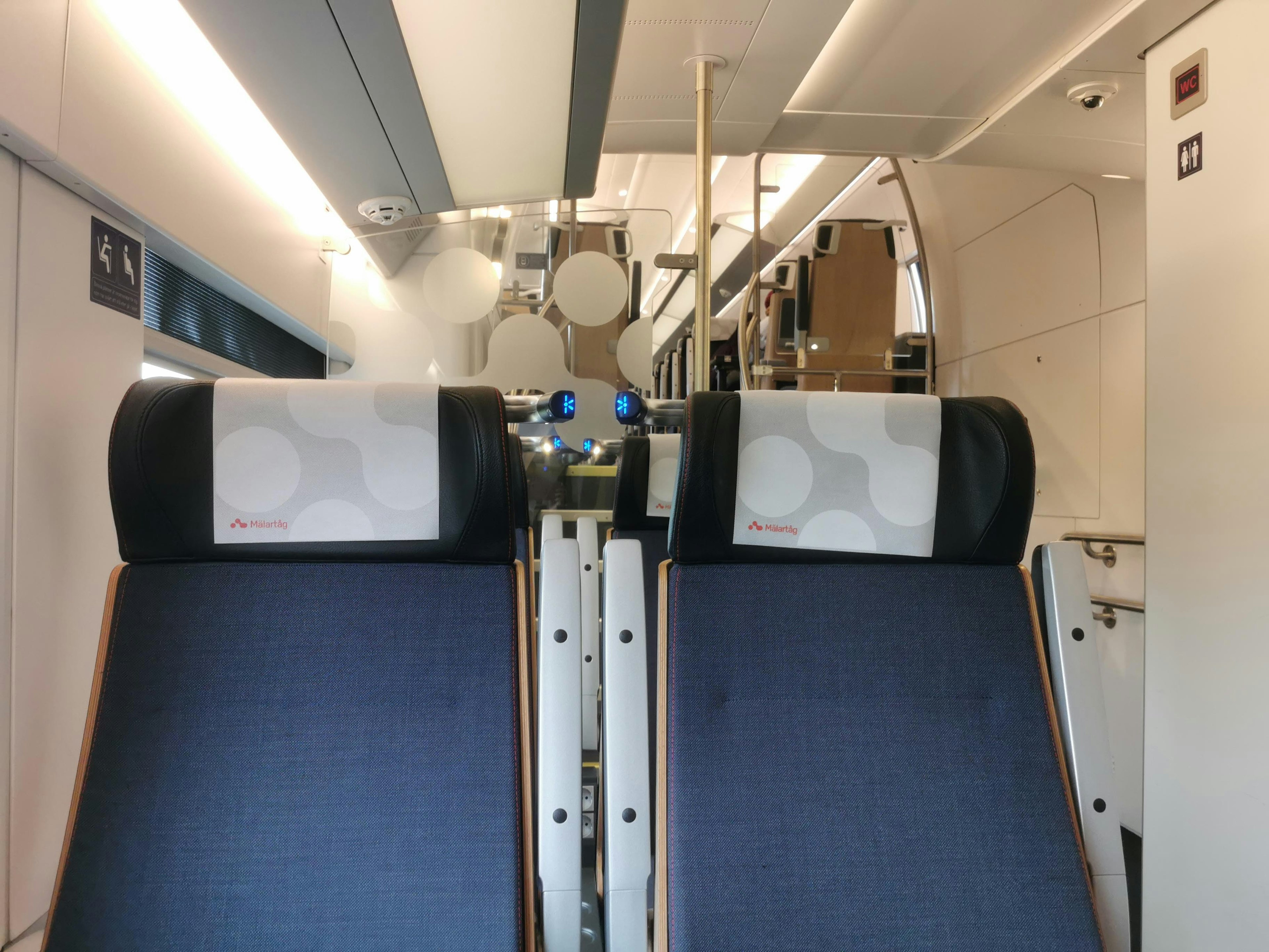 Interior view of an airplane cabin with seats and overhead compartments