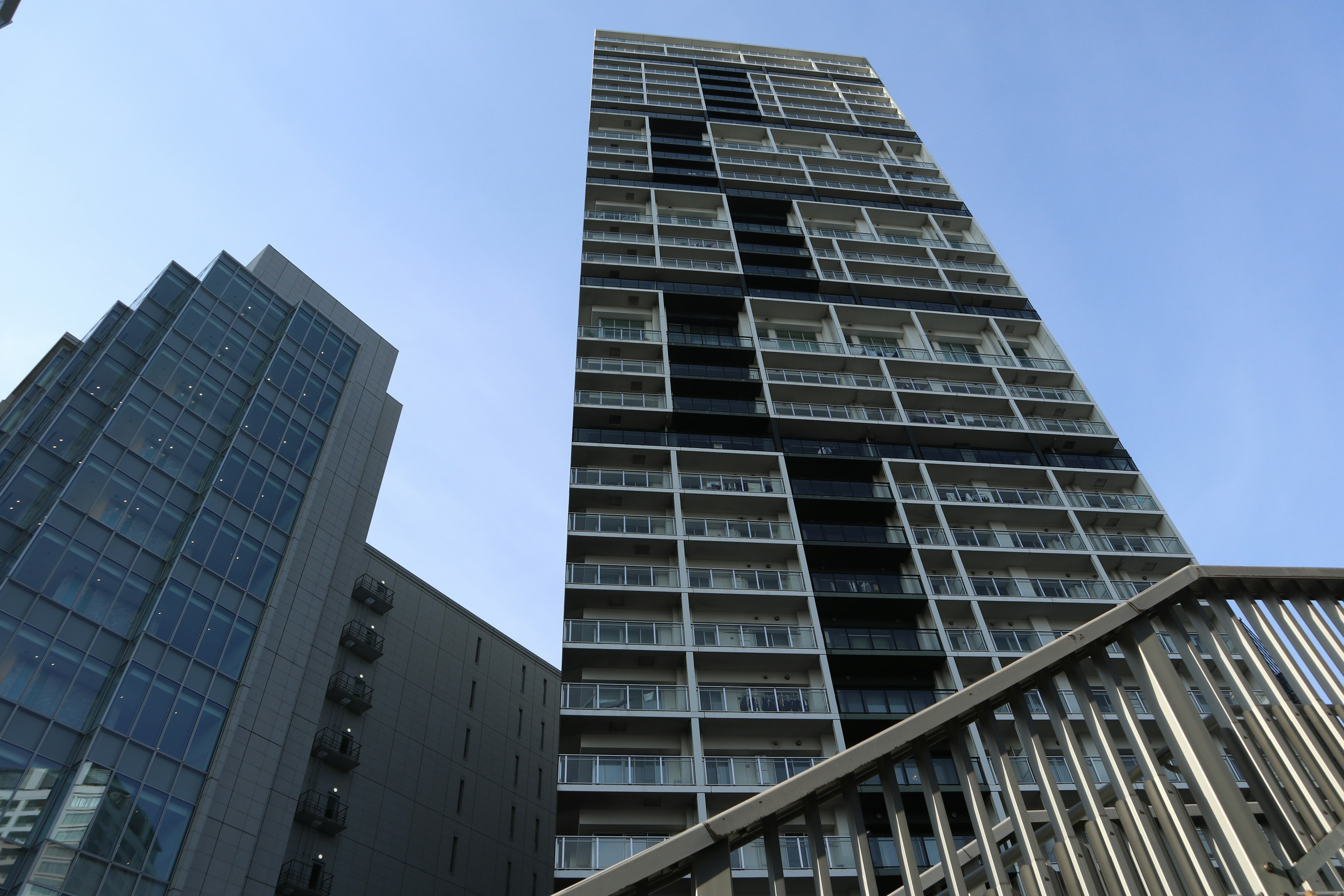 Modern building exterior near skyscrapers with blue sky