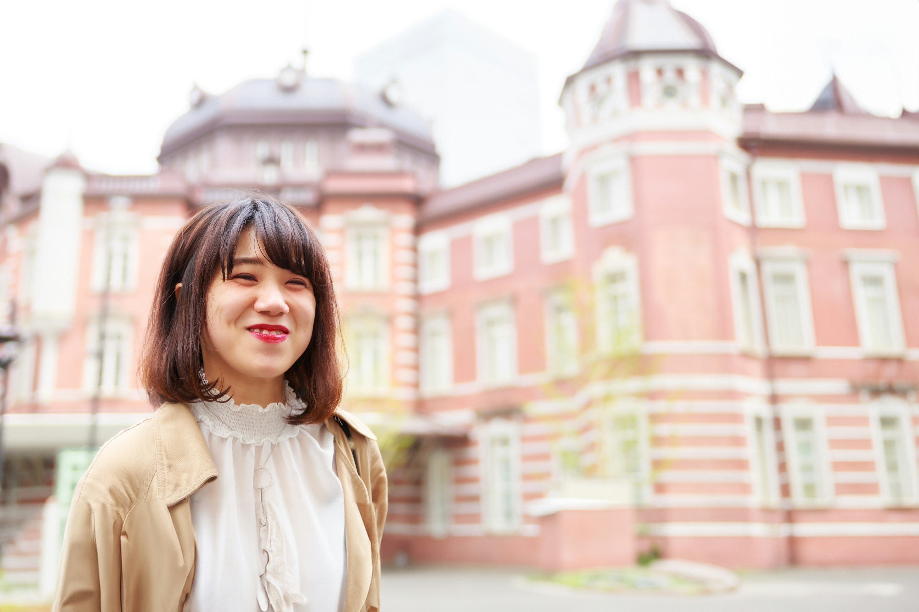 A woman smiling in front of a historic building