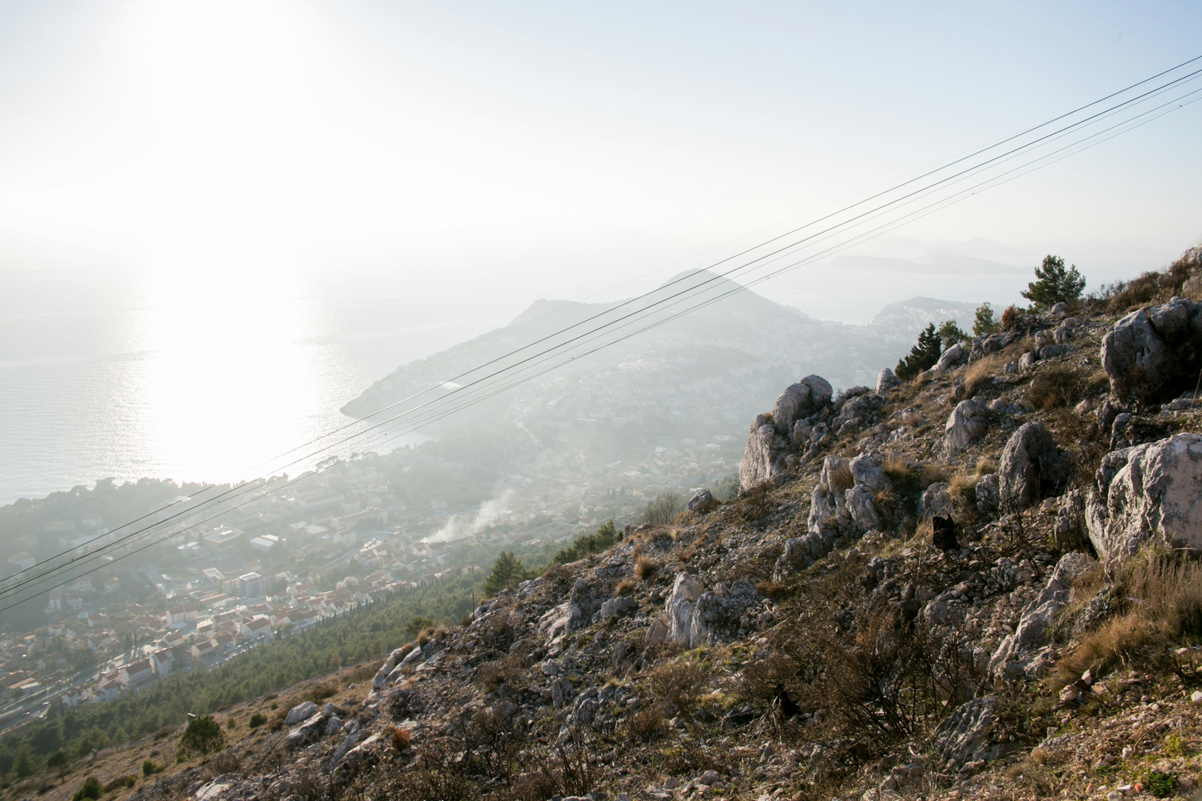 View of the sea from a mountain slope with misty landscape