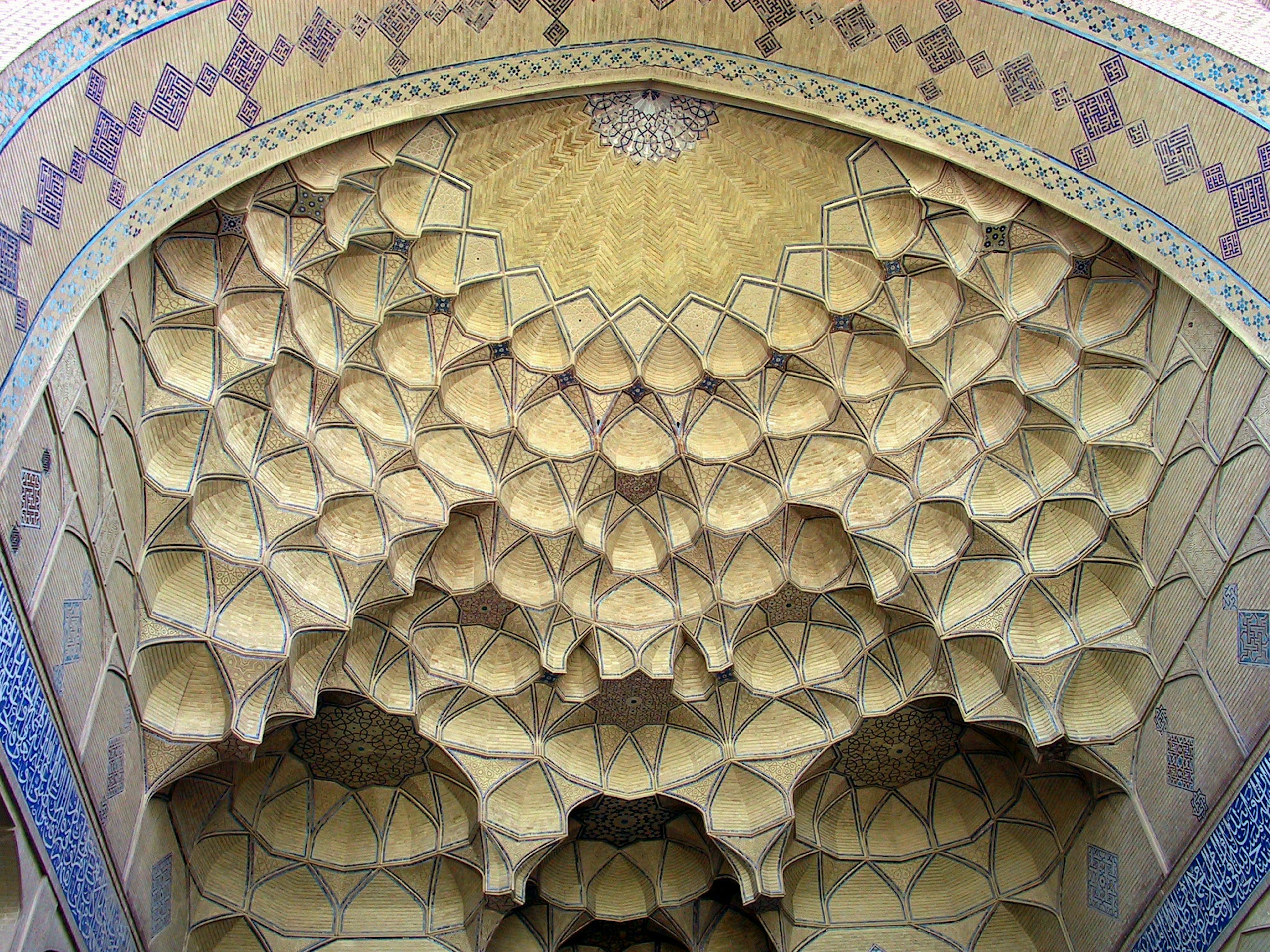 Decorative arch ceiling featuring intricate geometric patterns in yellow and blue hues