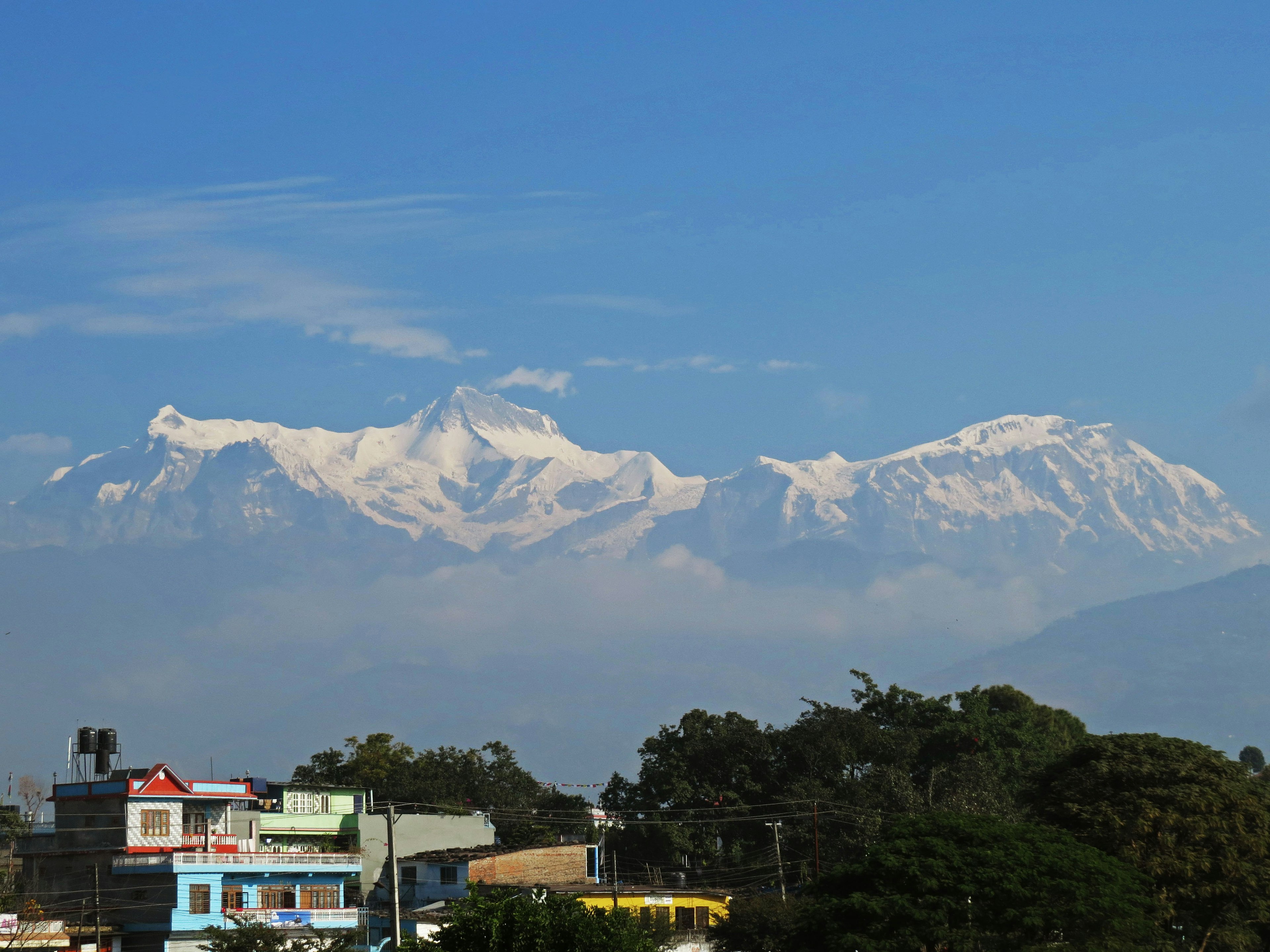 Snow-covered mountains with a clear blue sky