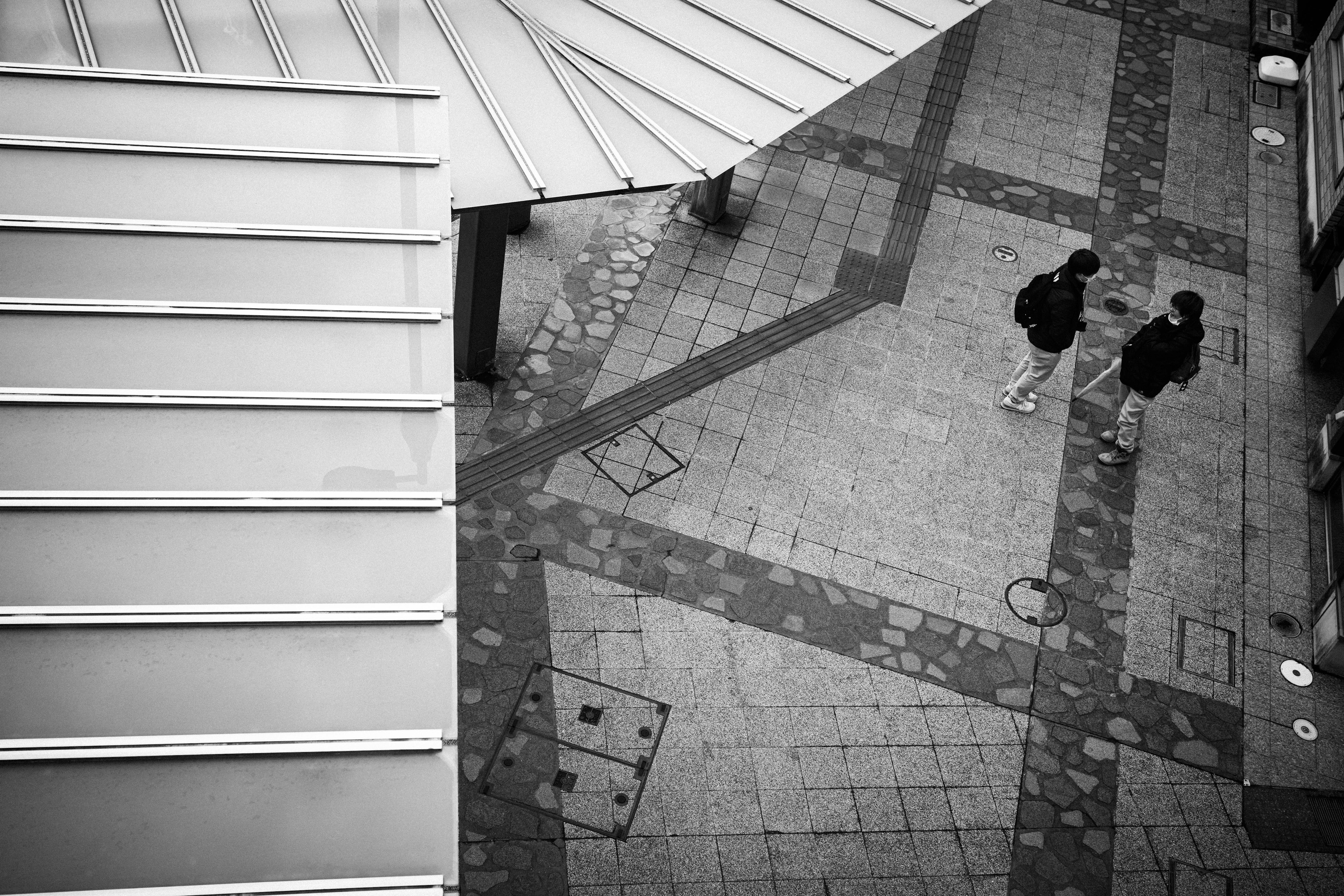 Aerial view of a city street with two pedestrians