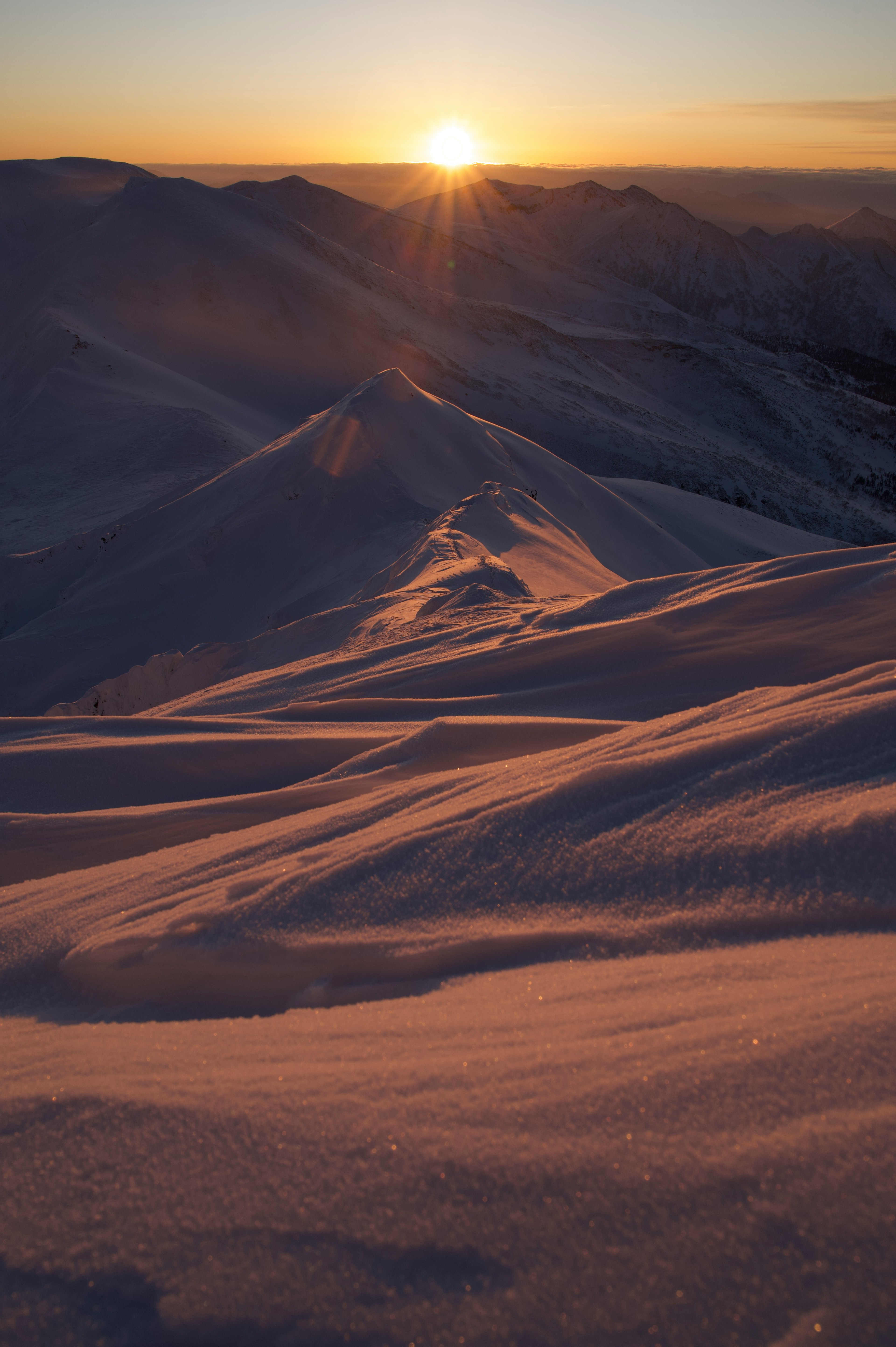 Montagnes enneigées avec un soleil levant