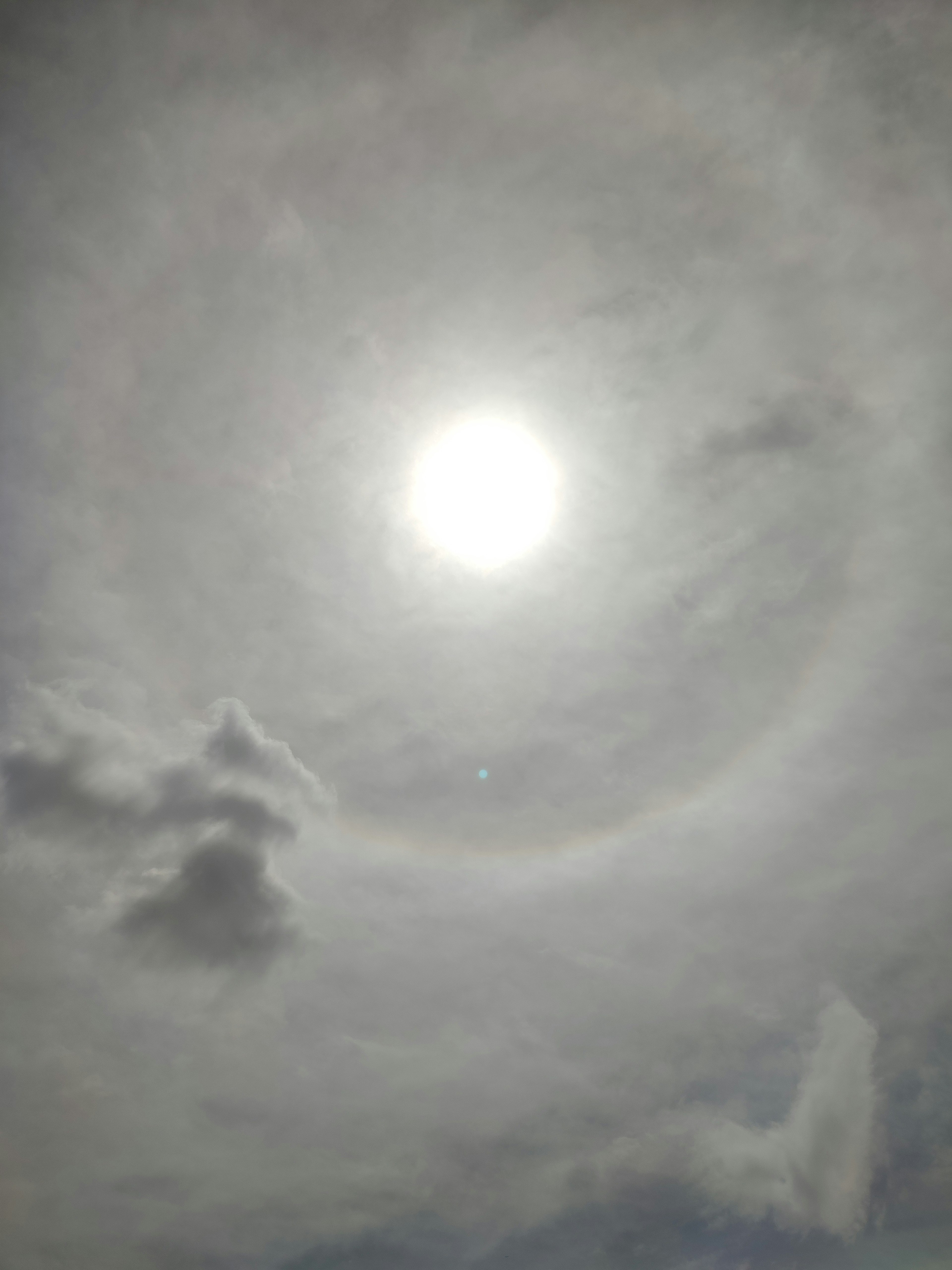 Photo du ciel avec un phénomène de halo autour du soleil