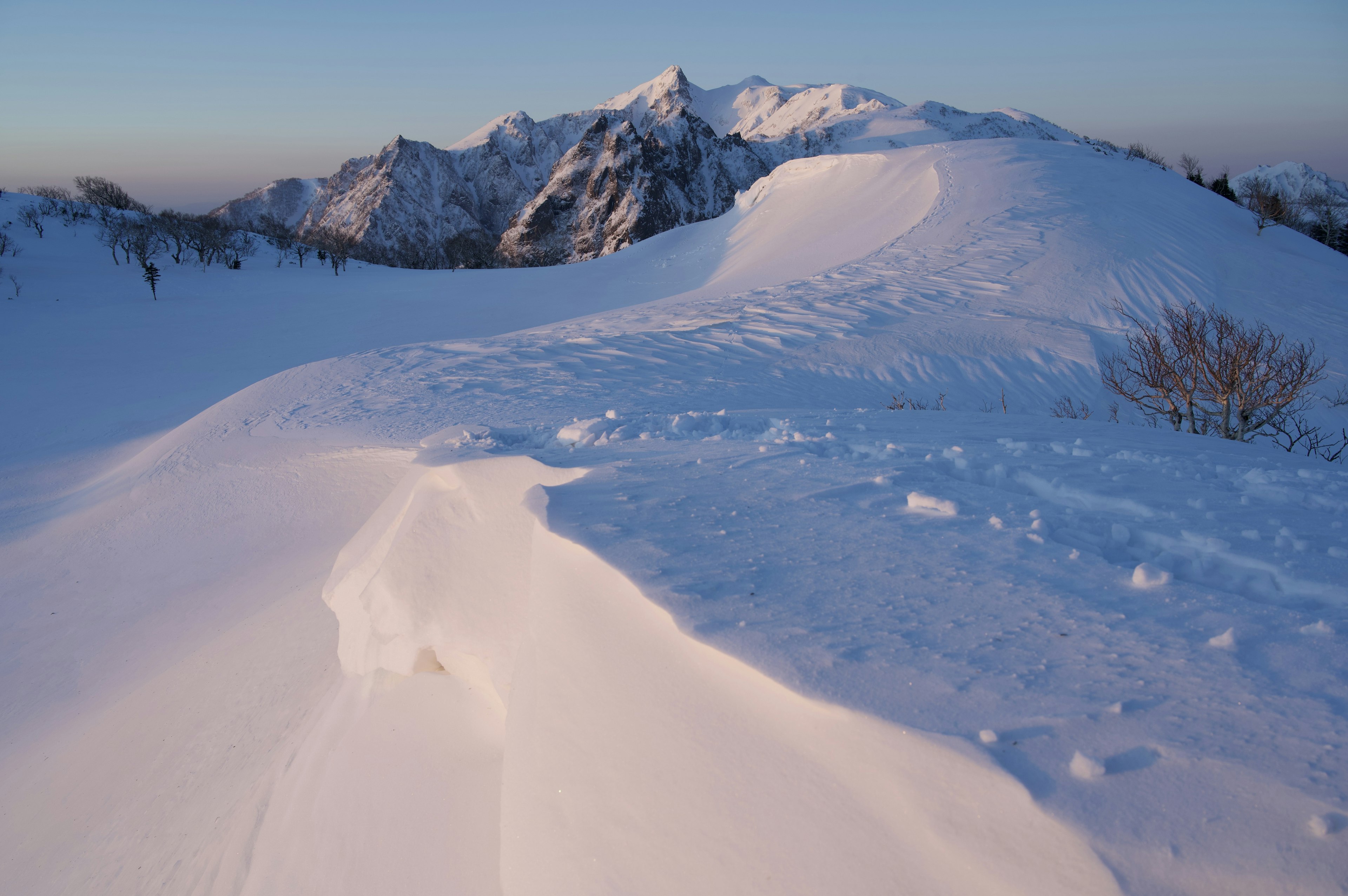 Snow-covered mountain landscape with blue sky