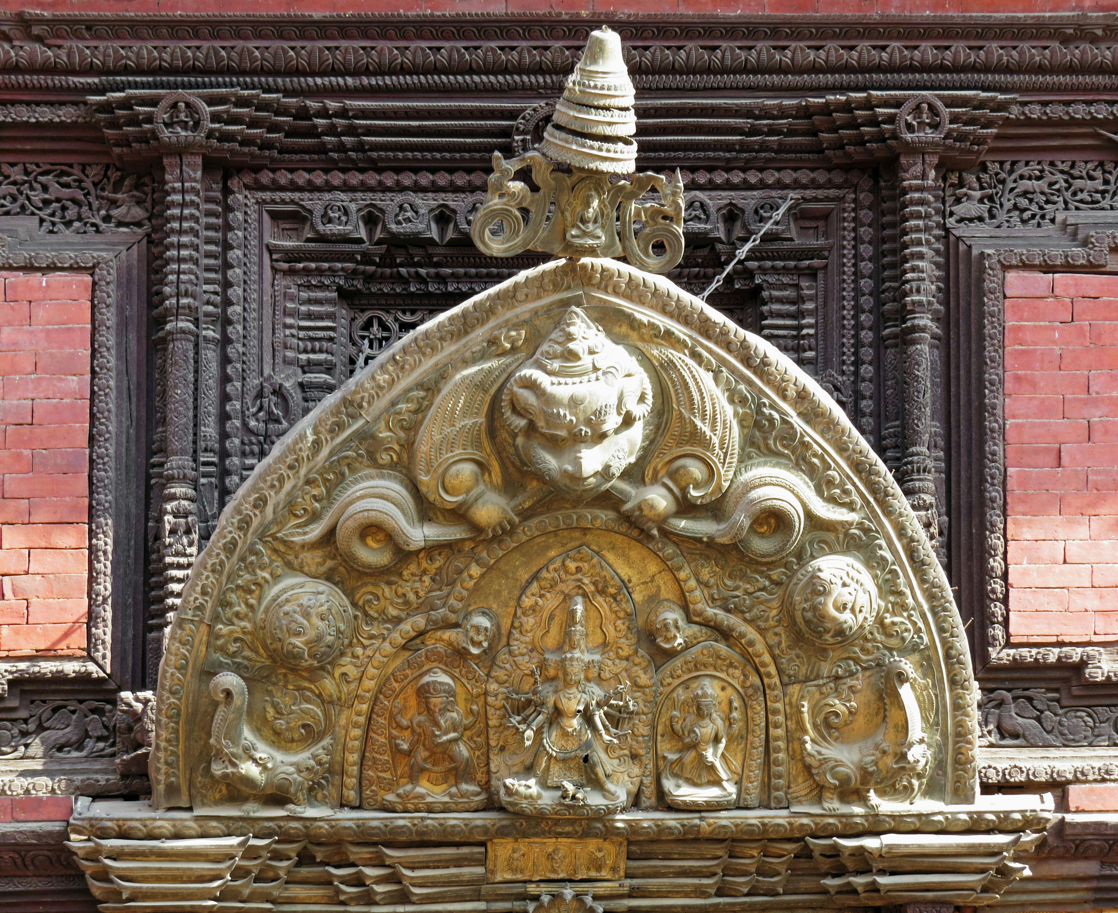 Decorative stone carving and sacred symbols on the upper part of a building