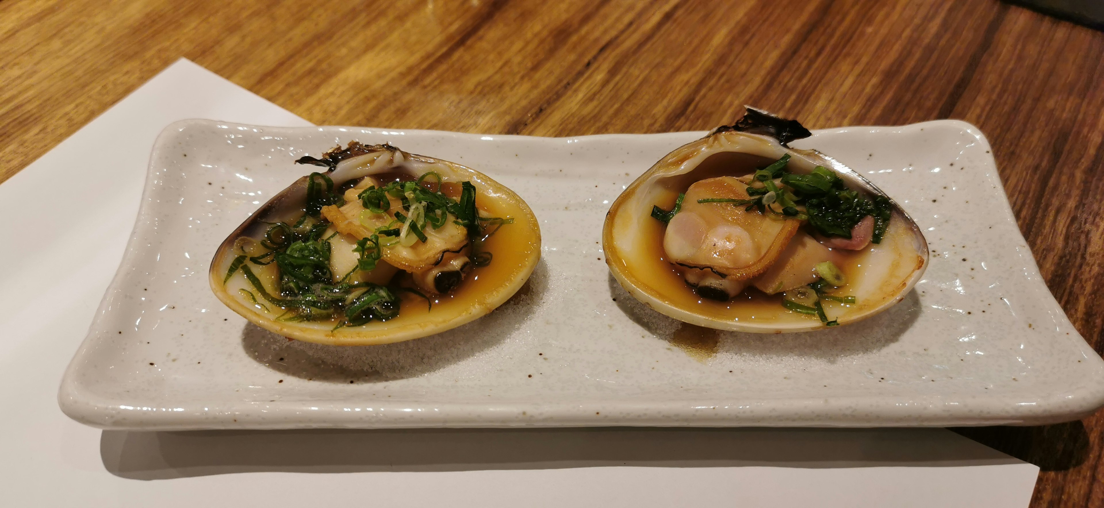 Two fresh shellfish dishes served in shells